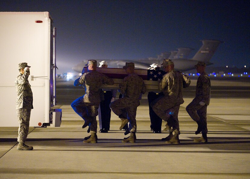 A Marine Corps carry team transfers the remains of Staff Sgt. Mark A. Wojciechowski, 25, of Cincinnati, Ohio, at Dover Air Force Base, Del., May 1. Staff Sgt. Wojciechowski was assigned to 7th Engineer Support Battalion, 1st Marine Logistics Group, I Marine Expeditionary Force, Camp Pendleton, Calif.  (U.S. Air Force photo/Tom Randle)  