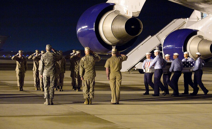 A Navy carry team transfers the remains of Petty Officer 2nd Class Tyler J. Trahan of Freetown, Mass., at Dover Air Force Base, Del., May 1.   Petty Officer Trahan was assigned to Explosive Ordnance Disposal Unit Twelve in Norfolk, Va., and was deployed with an East Coast based Navy SEAL team.  (U.S. Air Force photo/Tom Randle)