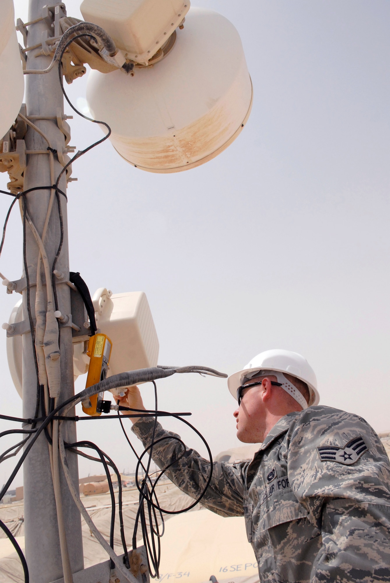 Senior Airman Michael Peyton, 379th Expeditionary Communications Squadron microwave communications technician, uses a voltmeter to check the signal strength and proper alignment of the microwave antenna, May 2, 2009, at an undisclosed location in Southwest Asia.  The microwave communications technicians provide voice and data via microwave transmission and equipment for microwave units used throughout forward operating locations in the U.S. Central Command's Area of Responsibility.  Airman Peyton hails from Copperas Cove, Texas and is deployed from Ramstein Air Base, Germany in support of Operations Iraqi and Enduring Freedom and Combined Joint Task Force - Horn of Africa.  (U.S. Air Force photo/Senior Airman Andrew Satran/released)