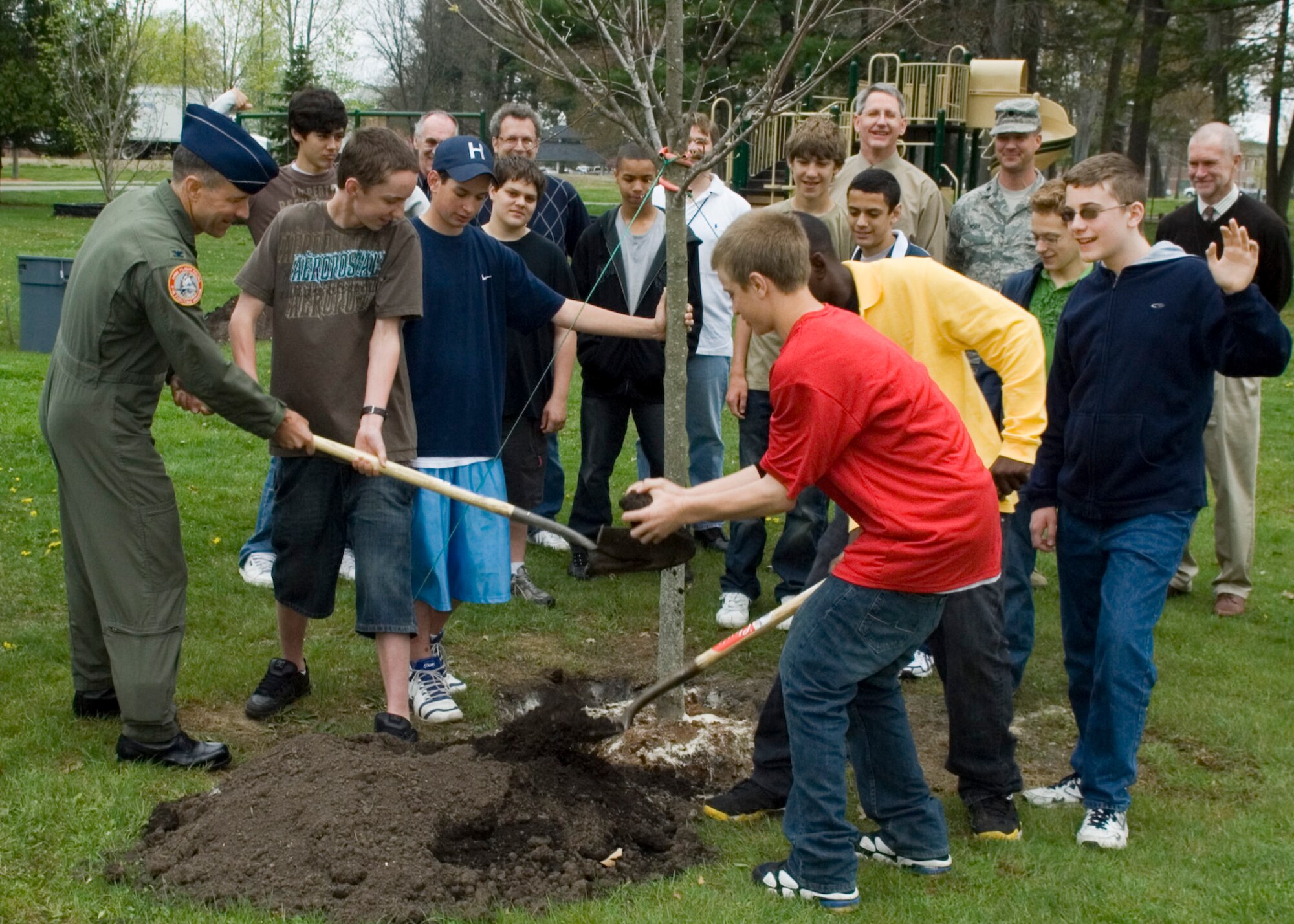 HANSCOM AIR FORCE BASE, Mass. –Hanscom Middle School students join Col. Dave Orr, 66th Air Base Wing commander and members of the 66th Mission Support Group Civil Engineering in celebrating Arbor Day by planting a tree in Castle Park on May 1. For the 22nd consecutive year Hanscom has maintained its Tree City USA status. (U.S. Air Force photo by Rick Berry) 
