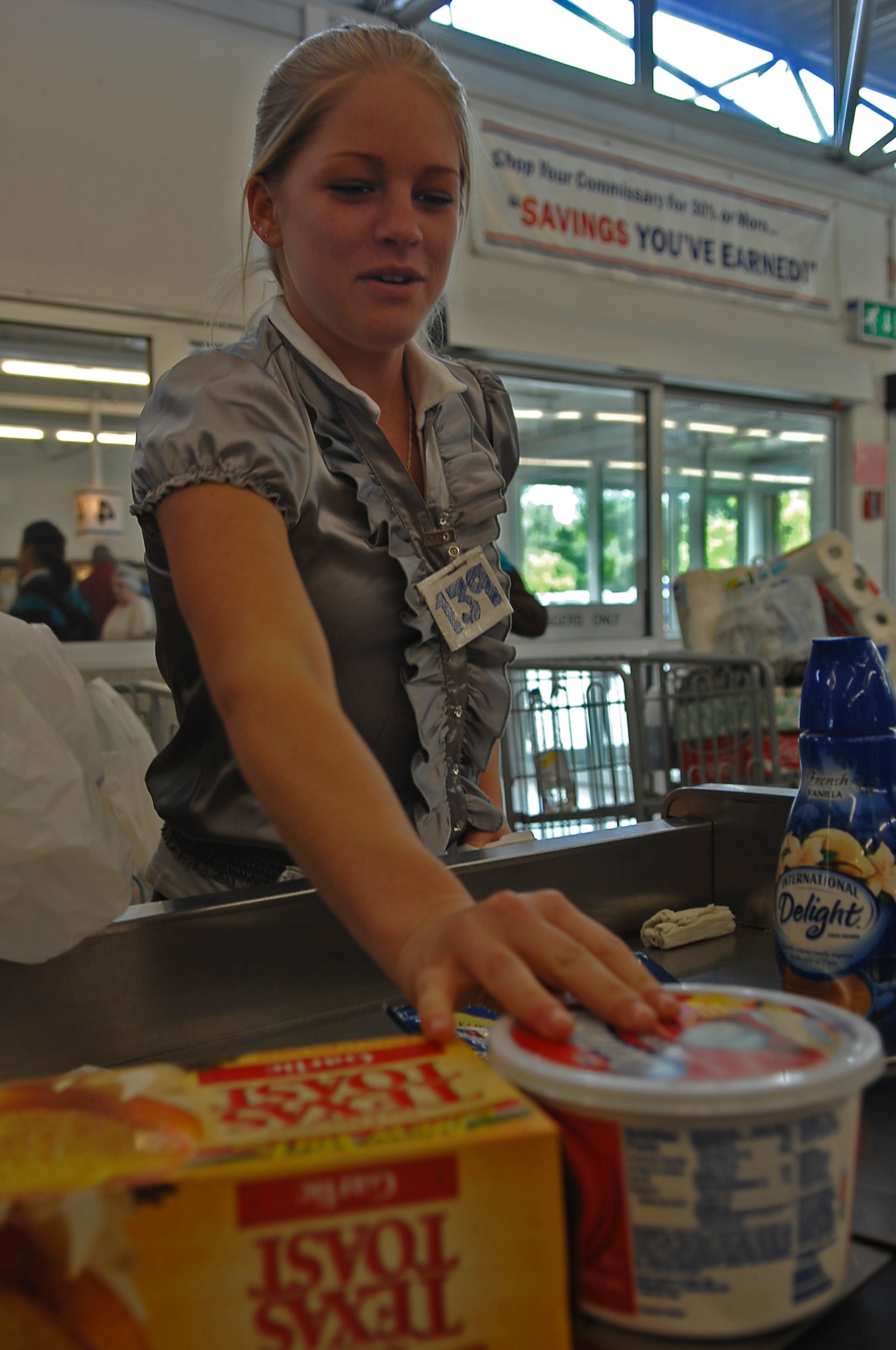Chelsea Bachmann, commissary bagger, bags a customer's groceries, Ramstein Air Base, Germany, April 23, 2009. Commissary baggers are self-employed and work under a license agreement with the installation commander. (U.S. Air Force photo by Airman 1st Class Tony R. Ritter)