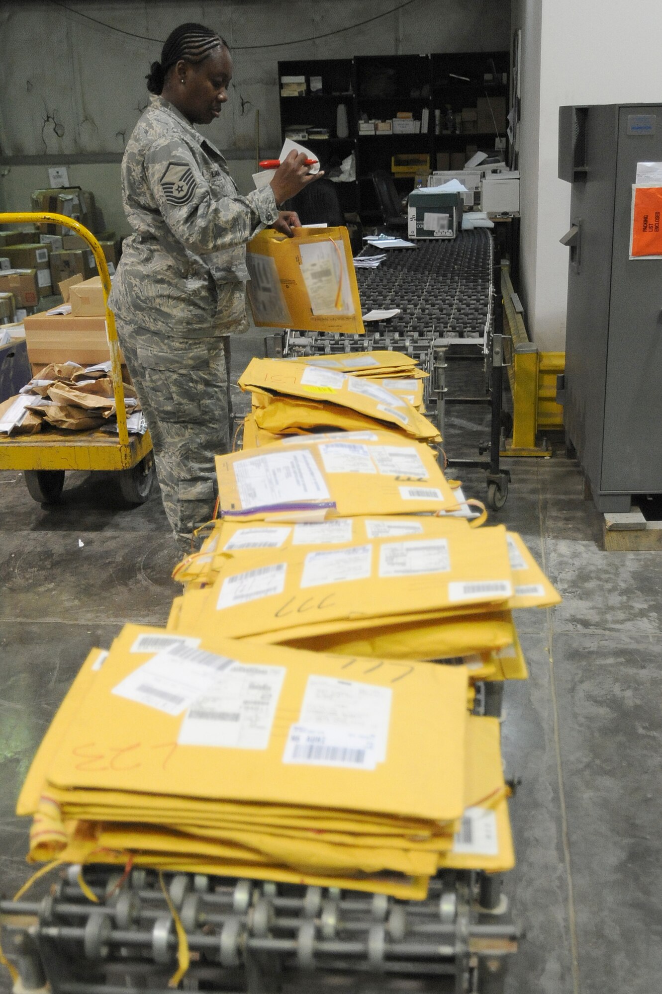Master Sgt. Dorothy Langford, 380th Expeditionary Logistics Readiness Squadron, checks inbound packages, April 24 at an undisclosed location in Southwest Asia. The receiving section verifies stock numbers and accounts for each item, matching it against the packing slip to ensure all items have arrived. Sergeant Langford is deployed from Spagdahlem AB, Germany and hails from Columbus, Miss. (U.S. Air Force photo by Senior Airman Brian J. Ellis) (Released)