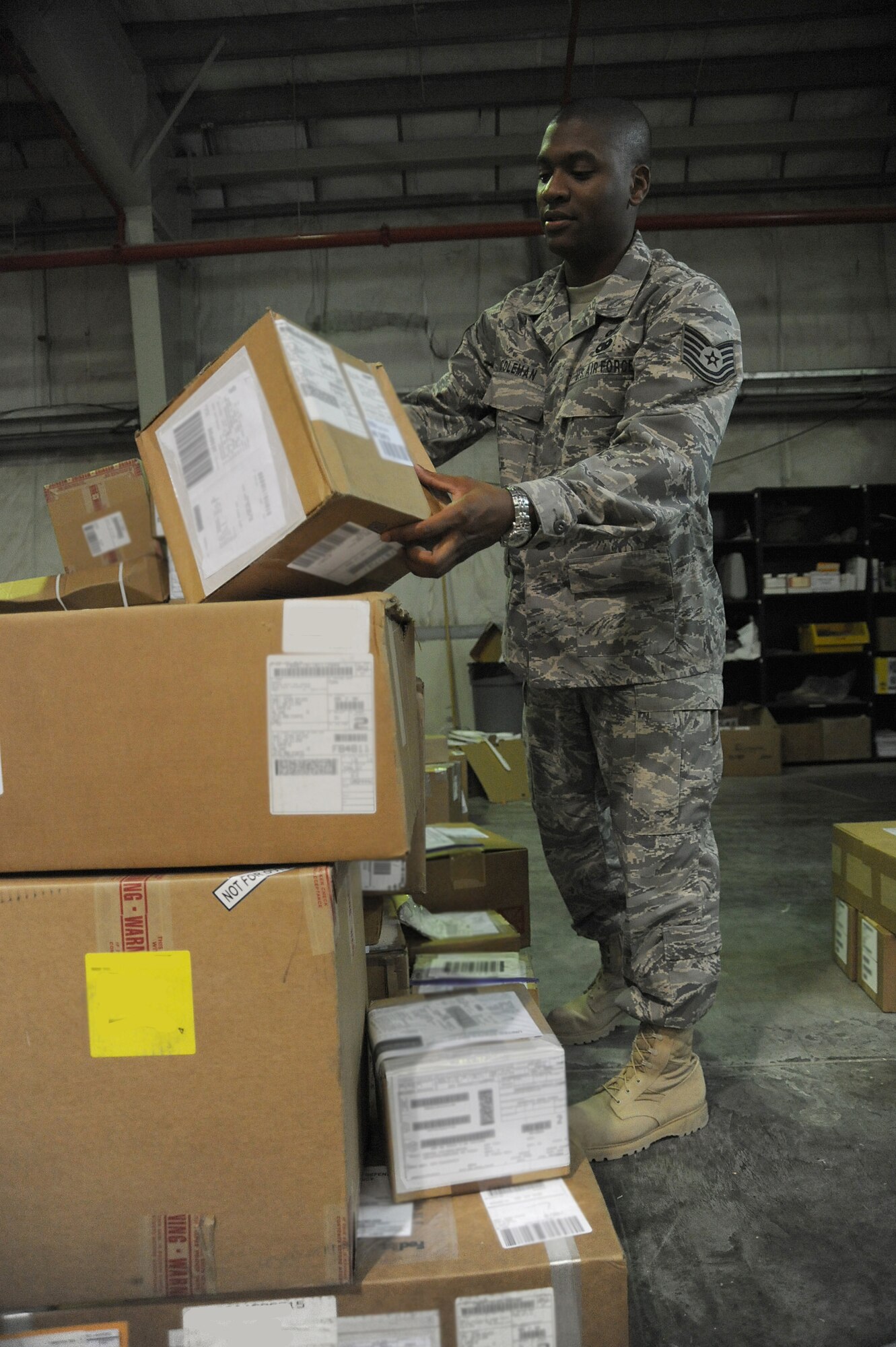 Tech Sgt. Jeremie Coleman, 380th Logistics Readiness Squadron, inspects boxes during the in-checking process at the receiving dock, April 24 at an undisclosed location in Southwest Asia. The receiving section verifies stock numbers and accounts for each item, matching it against the packing slip to ensure all items have arrived. Sergeant Coleman is deployed from the Air National Guard Combat Readiness Training Center, Gulfport, Miss. and hails from Meridian, Miss. (U.S. Air Force photo by Senior Airman Brian J. Ellis) (Released)