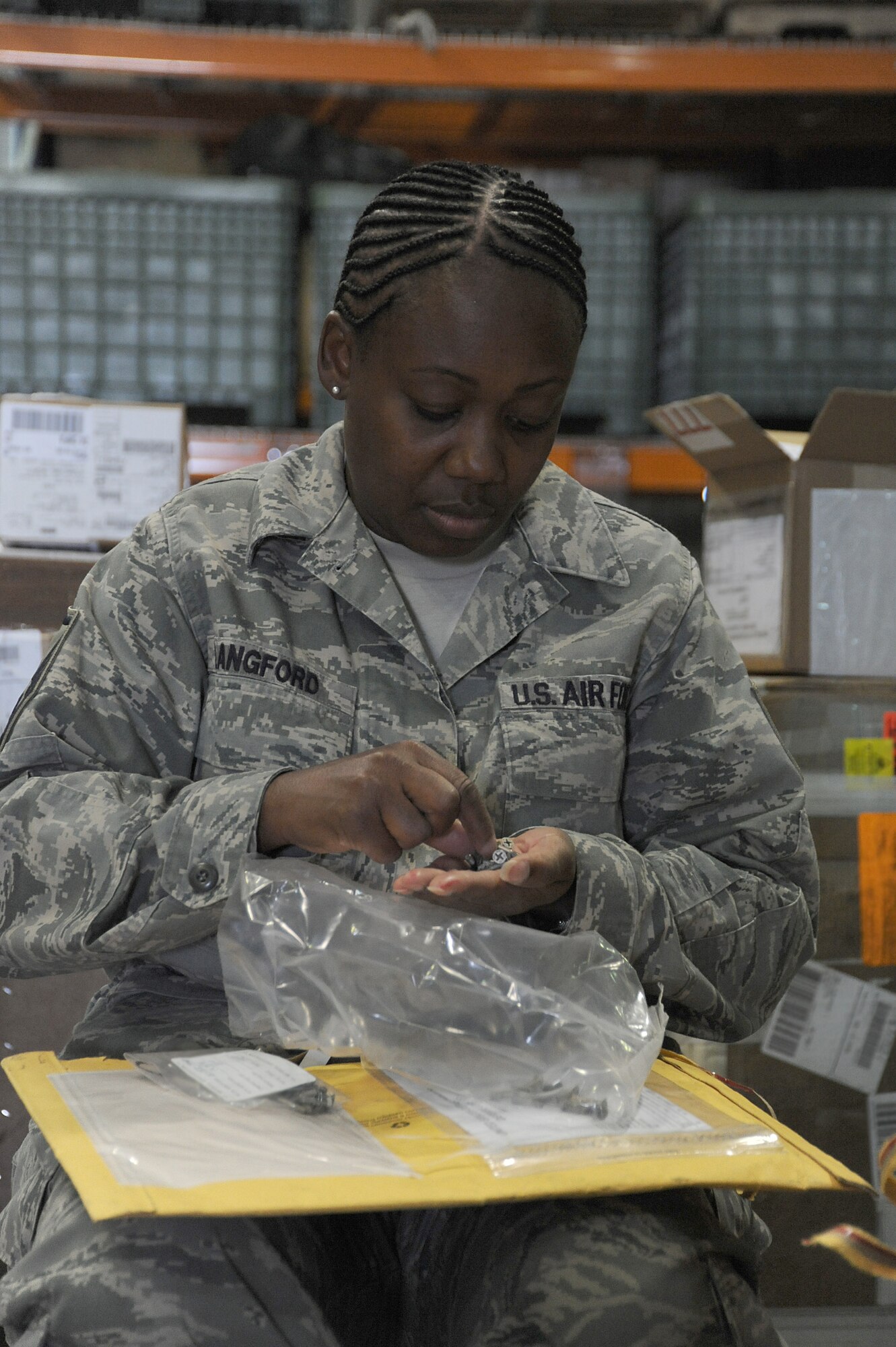 Master Sgt. Dorothy Langford, 380th Logistics Readiness Squadron, counts nuts and bolts from a package at the receiving dock, April 24 at an undisclosed location in Southwest Asia. The receiving section counts each item and matches it against the packing slip to ensure all items have arrived. Sergeant Langford is deployed from Spagdahlem AB, Germany and hails from Columbus, Miss. (U.S. Air Force photo by Senior Airman Brian J. Ellis) (Released)