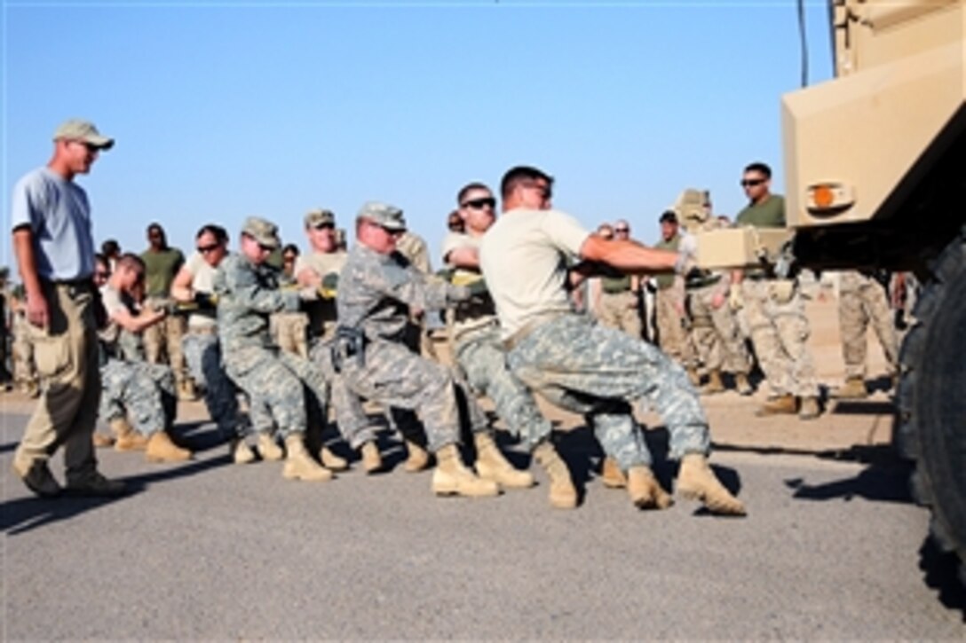 A team of eight U.S. Army soldiers pulls a 14-ton Mine Resistant Ambush Protected vehicle during the Firemen's Challenge competition on Camp Ramadi, Iraq, April 19, 2009. About 80 troops competed in seven events put on by Camp Ramad's Combat Stress Team and Fire Department.