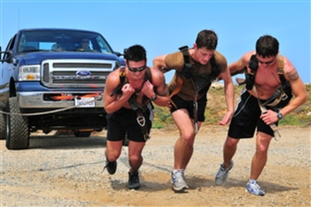 U.S. Navy search and rescue swimmers pull a pick-up truck during a competition on Naval Air Station North Island, Coronado, Calif., April 30, 2009. The competition is held annually and unites rescue swimmers from their duty stations across the globe to participate in a physically demanding race to test strength and endurance.