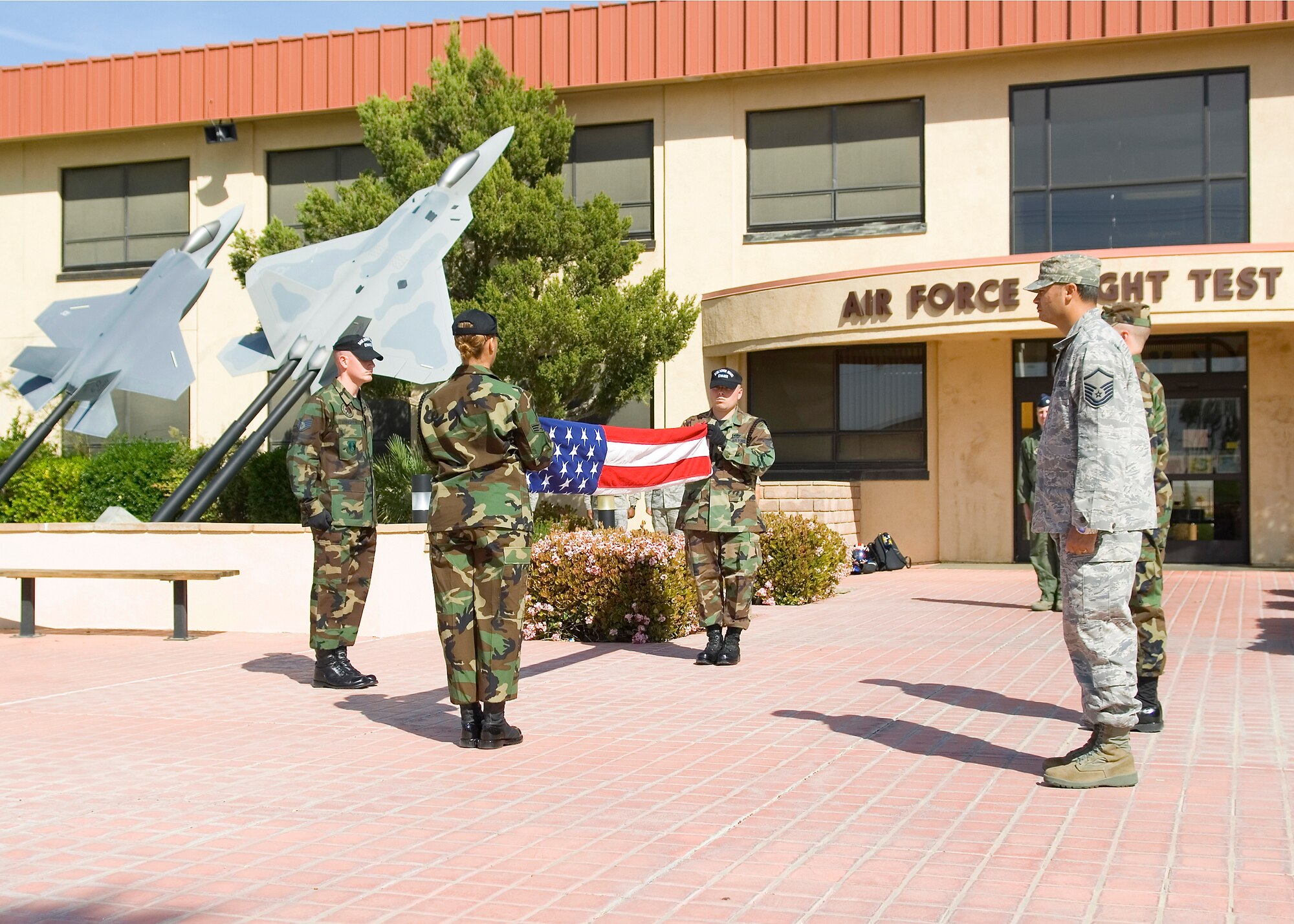 The Edwards Blue Eagle Honor Guard members fold the flag during a retreat ceremony at the Air Force Flight Test Center Headquarters April 30. The 412th Operations Group hosted the retreat ceremony. (U.S. Air Force photo/Mike Cassidy)
