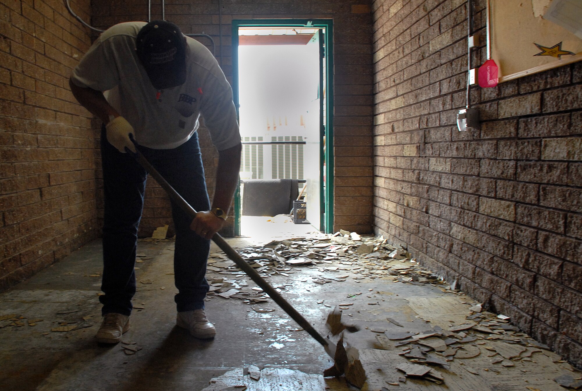 Greg Birdwell, Birdwell Brother’s Construction owner, scrapes up flooring from the bowling center kitchen May 5. The bowling center is undergoing renovations to improve the bathrooms and kitchen facilities and will re-open Jun 1. (Photo by Staff Sgt. Aaron C. Oelrich)