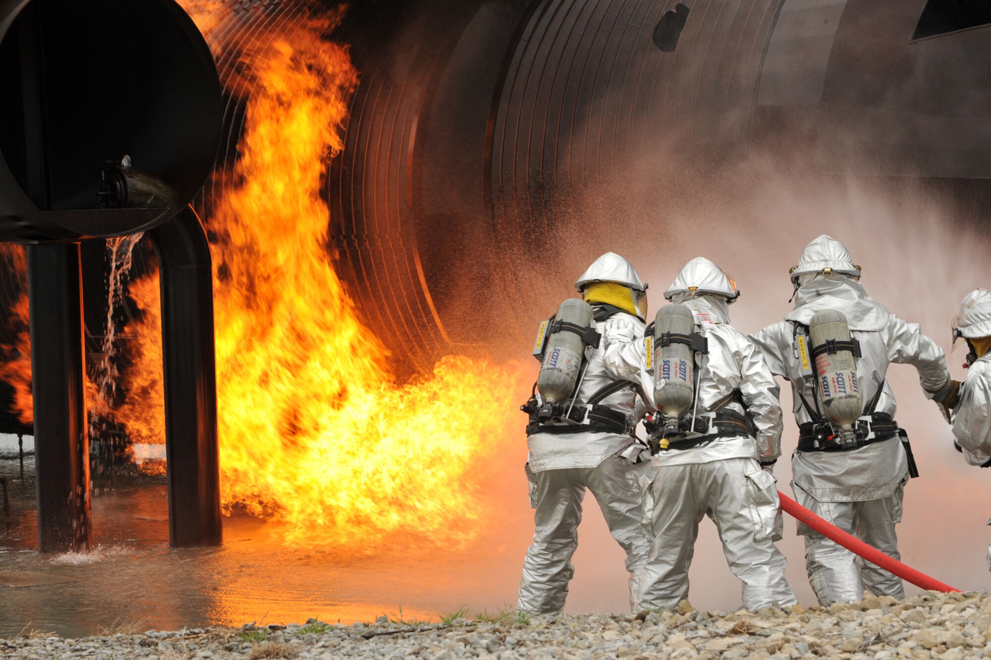 OFFUTT AIR FORCE BASE, Neb. -- Offutt firefighters begin to extinguish the flames of simulated aircraft fire trainer during a joint training exercise. Firefighters from Offutt AFB, Eppley Field and guard and reserve units participated in a joint training exercise for disaster preparation here May 4. 
U.S. Air Force Photo by Charles Haymond
