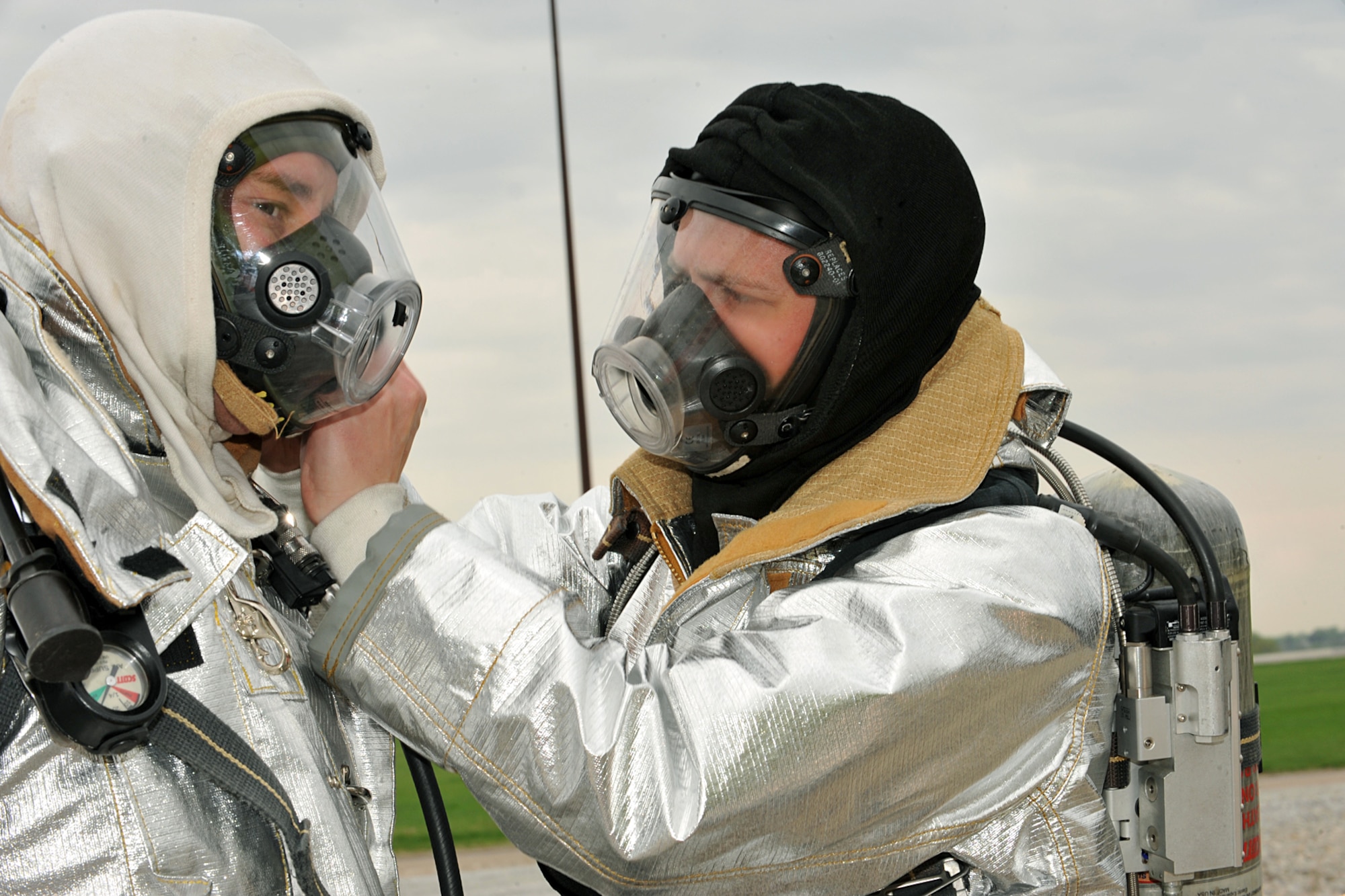 OFFUTT AIR FORCE BASE, Neb. -- KETV reporter Jeff Van Sant, dons his firefighting equipment as 55th Civil Engineer Squadron firefighter Matthew Grimes assist. Firefighters from Offutt AFB, Eppley Field and guard and reserve units participated in a joint training exercise for disaster preparation here May 4. 
U.S. Air Force Photo by Charles Haymond
