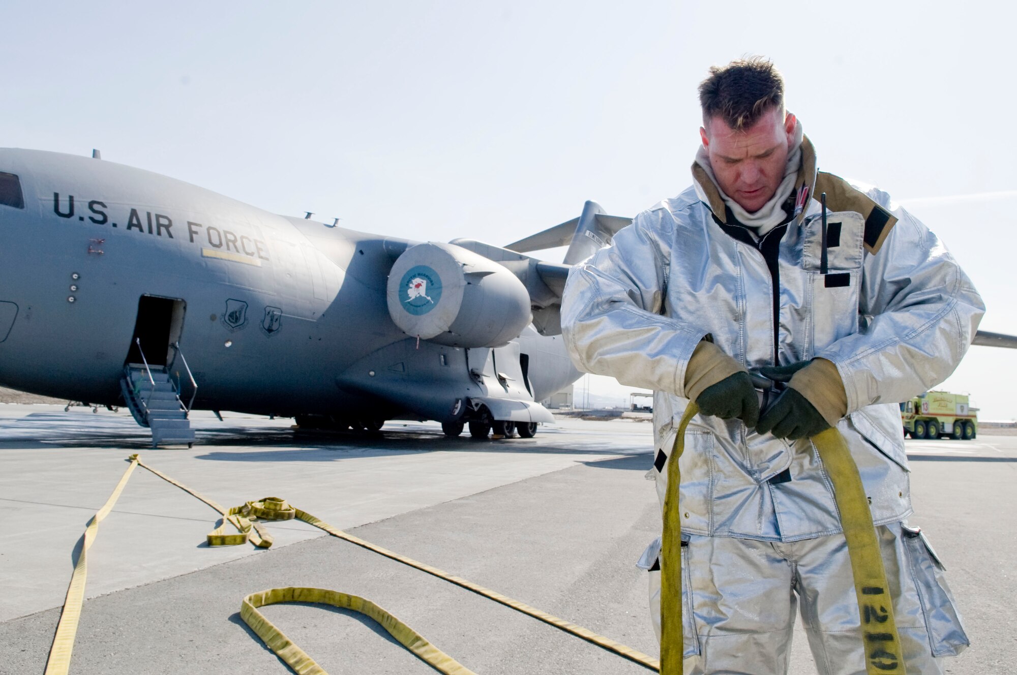 ELMENDORF AIR FORCE BASE, Alaska --Tech. Sgt. Jeffrey Tongate secures two fire hoses together during a training exercise April 21, 2009. Tongate is a fire fighter from the 3rd Civil Engineer Squadron and he also plays on the Alaska Wild, an indoor professional football team. (U.S. Air Force photo/Senior Airman Jonathan Steffen)  