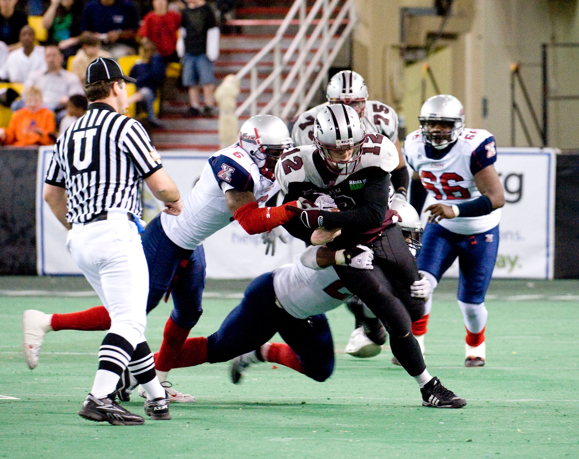ANCHORAGE, Alaska--Staff Sgt. Earl Mason pushes through Bloomington Extreme players with the football in hand May 4, 2009. Mason is the non-commission officer in charge of emergency management of logistics from the 3rd Civil Engineer Squadron and he also plays on the Alaska Wild, an indoor professional football team. (U.S. Air Force photo/Senior Airman Jonathan Steffen)  