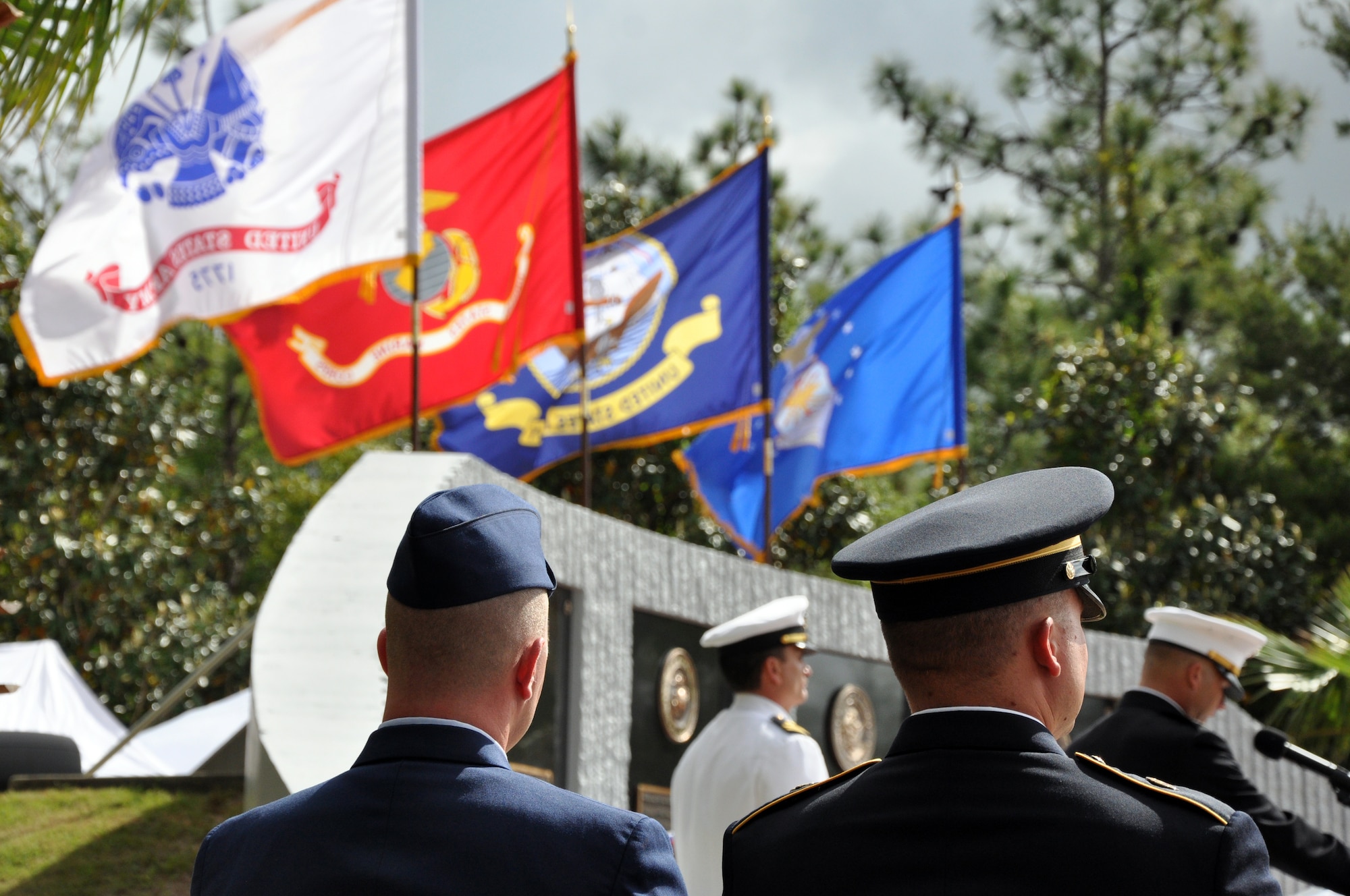 EGLIN AIR FORCE BASE, Fla. -- An Airman and a Soldier listen to names read off the Explosive Ordnance Disposal Memorial during the 40th Annual EOD Memorial Service May 2, at the Kauffman EOD Training Complex. Six servicemembers were added to the memorial wall bringing the total to 238 names. The total now stands at 238 names. The men and women whose names are on the Memorial must be graduates of an approved EOD School who have given their lives on active duty as a result of an EOD mission since the declaration of World War II. (U.S. Air Force photo/ Airman Anthony Jennings)