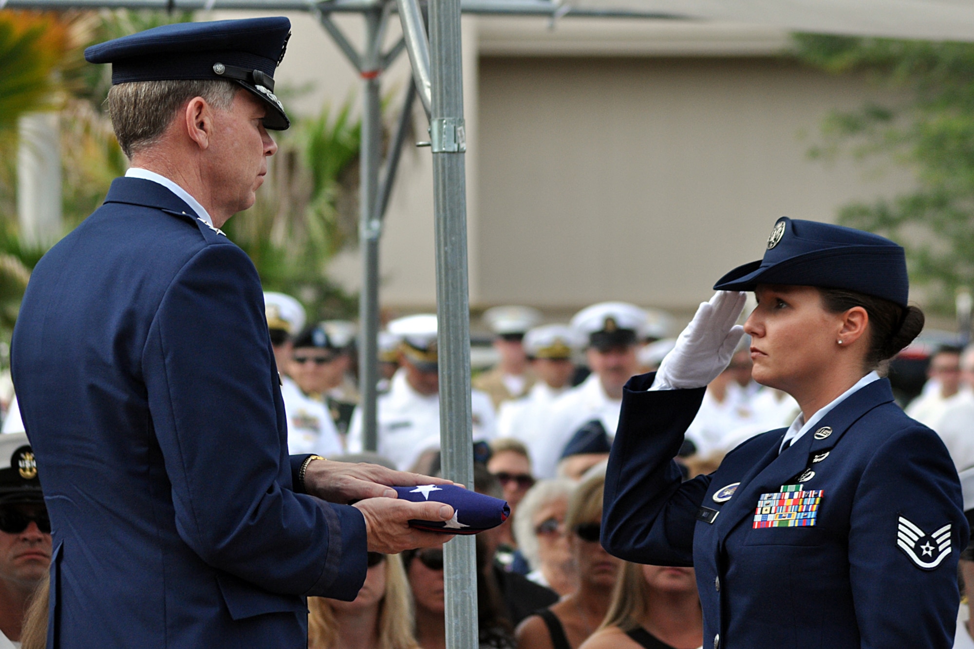 EGLIN AIR FORCE BASE, Fla. -- Air Force Maj. Gen. Del Eulberg, Air Force Civil Engineer, prepares to present a flag to the family of Tech. Sgt. Anthony Capra, an Explosive Ordnance Disposal technician who died in the line of duty April 9, in Iraq. The ceremony was part of the 40th Annual EOD Memorial Service May 2 at the Kauffman EOD Training Complex. During the service, six servicemembers' names were added to the Memorial. The total now stands at 238 names. The men and women whose names are on the Memorial must be graduates of an approved EOD School who have given their lives on active duty as a result of an EOD mission since the declaration of World War II. (U.S. Air Force photo/ Airman Anthony Jennings)