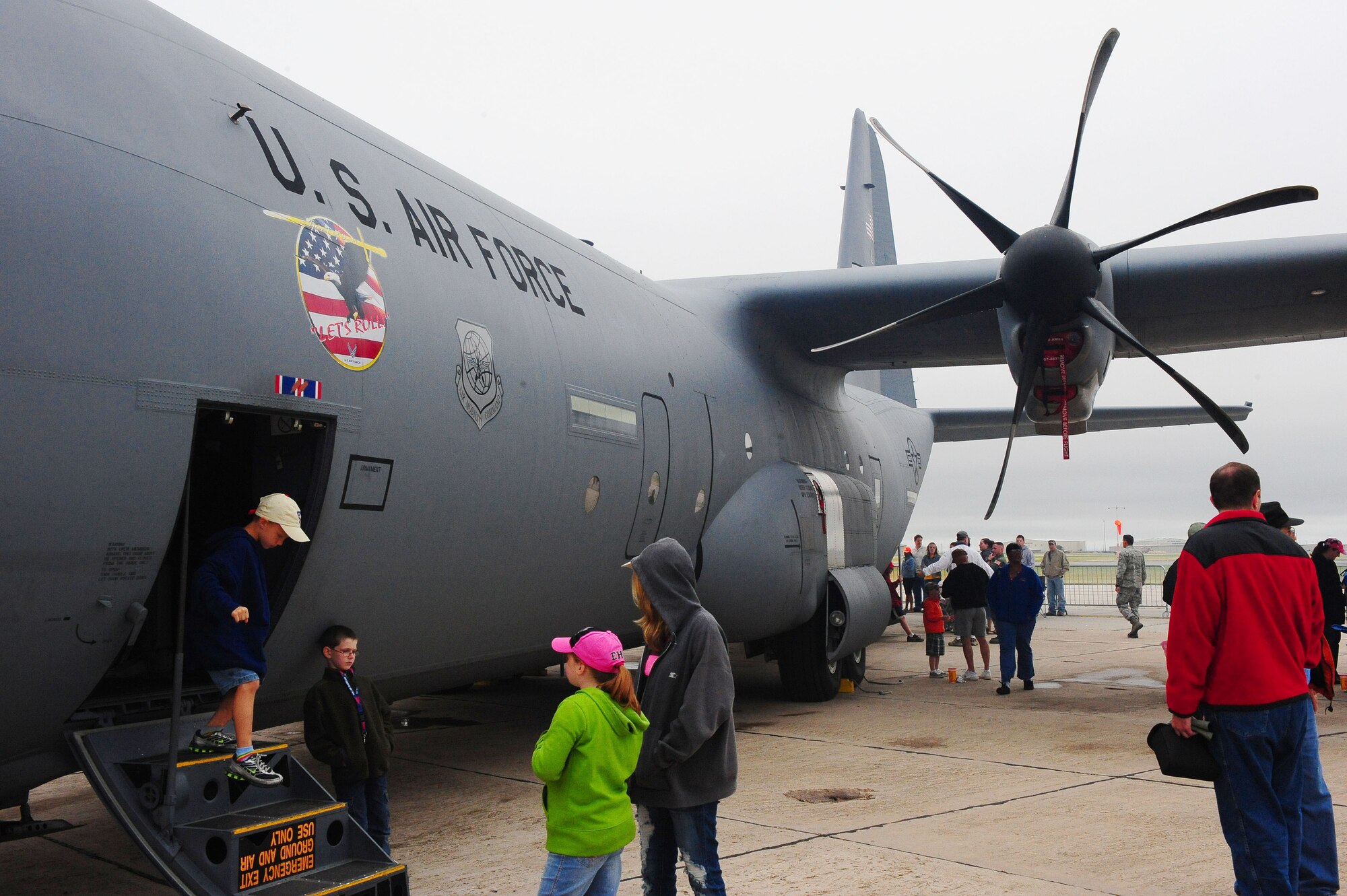 DYESS AIR FORCE BASE, Texas - Abilene residents enjoyed walking through a C-130 Hercules during the Big Country Airfest at the Abilene Regional Airport, May 2.  Despite the bad weather people came out to see the different static displays, vendors, and a chance to look inside the cockpits of the planes on the flight line.  Residents also saw air power in action with two Air Force jets performing a low-level fly over.  (U.S. Air Force photo by Staff Sgt. Connor Estes).  
