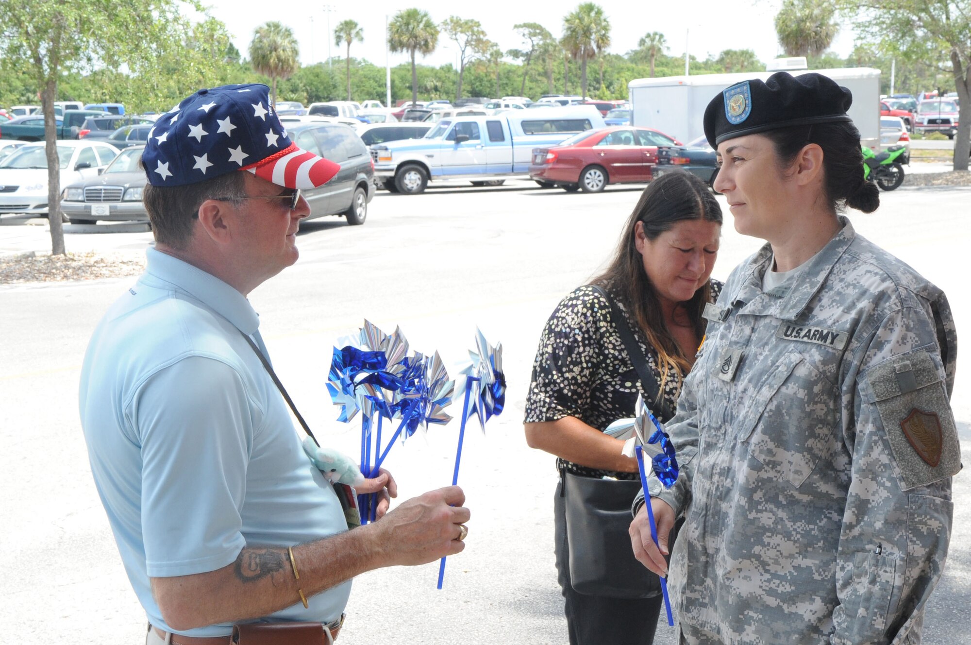 Sgt. 1st Class Gloria Stairs, United States Central Command talks with Mr. John Navarro, Family Advocacy, during "These Hands are not made for hitting" exhibit at the Base Exchange Apr. 30.  (U.S. Air Force photographer Senior Airman David Minor)