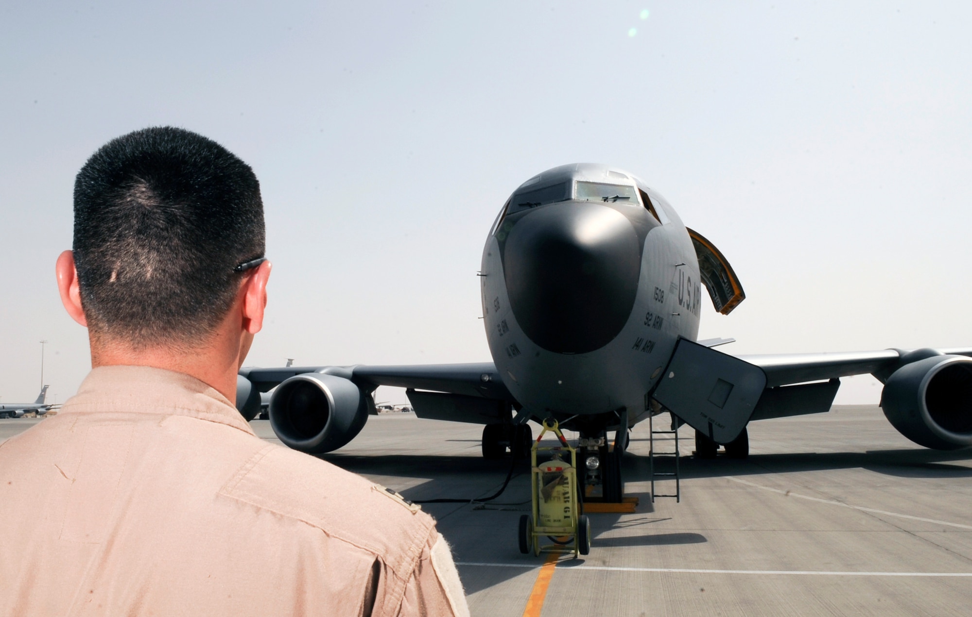 Capt. Andrew McLay, a pilot with the 340th Expeditionary Air Refueling Squadron at an air base in Southwest Asia, does a walk-around to check out the overall exterior of a KC-135 Stratotanker as part of his preflight check prior to refueling mission.  (U.S. Air Force Photo by Staff Sgt. Joshua Garcia/released) 