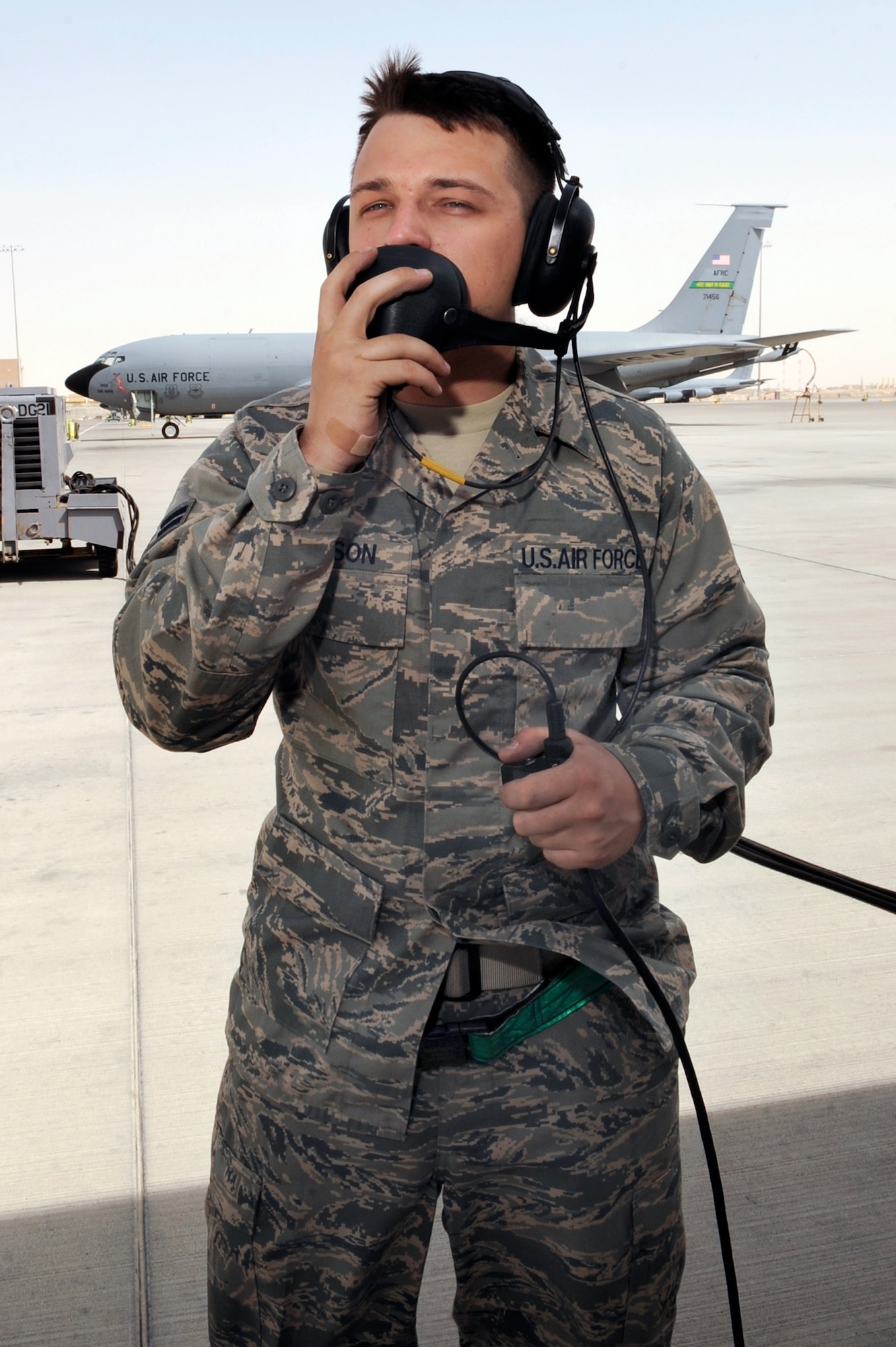 Airman 1st Class Justin Simpson, a crew chief with the 379th Expeditionary Aircraft Maintenance Squadron at an air base in Southwest Asia, talks with the pilot of a KC-135 Stratotanker via headset during the preflight check before a refueling mission. Airman Simpson serves as the "eyes on the ground" for the pilots, letting them know if everything is operating properly as they go through the checklist. (U.S. Air Force photo/Staff Sgt. Joshua Garcia)