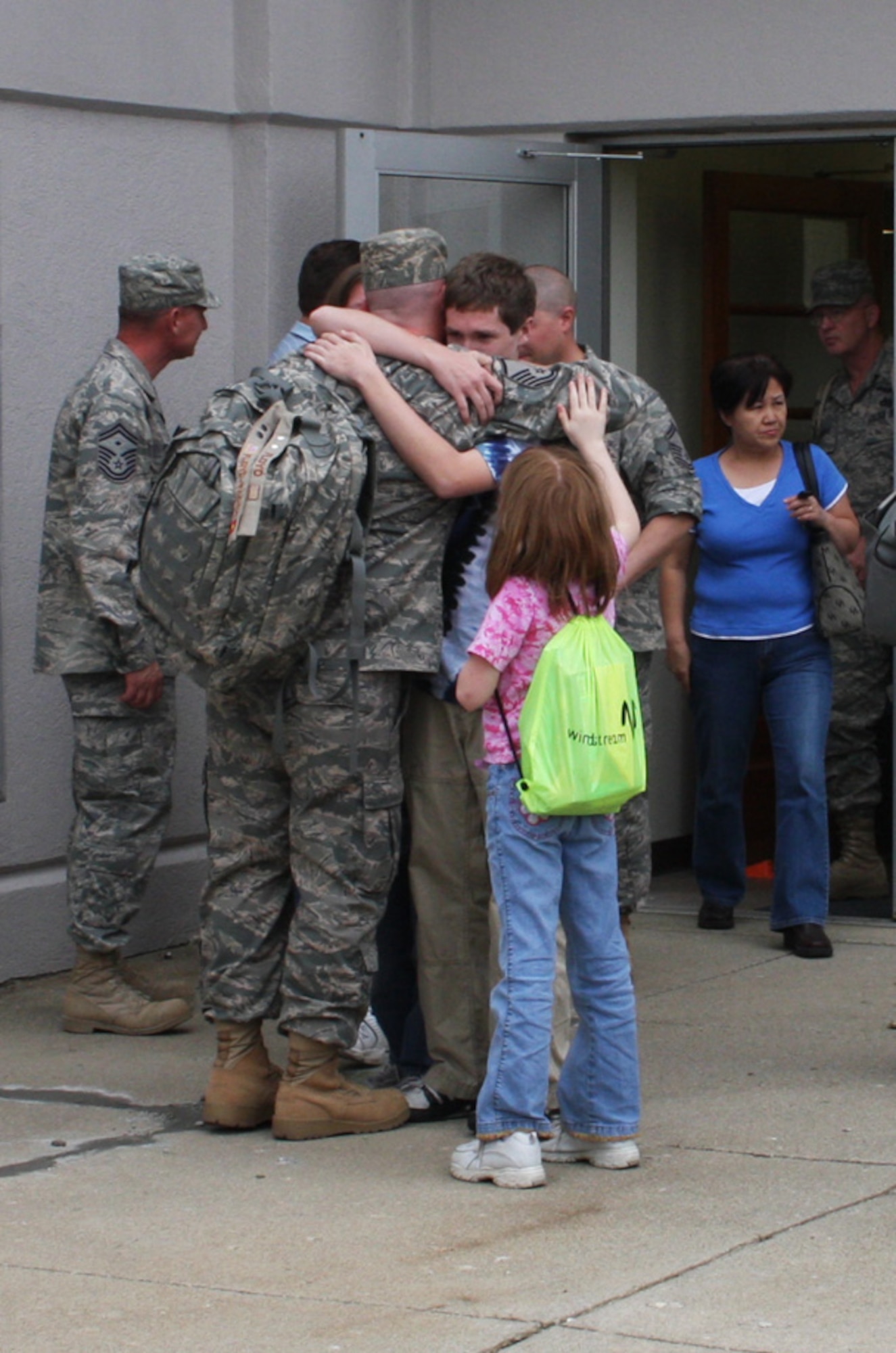 WRIGHT-PATTERSON AIR FORCE BASE, Ohio - Master Sgt. Donald Floyd, 87th Aerial Port Squadron, says good bye to his family before boarding the bus to take him to his flight.  Sergeant Floyd departed on April 24th with fellow reservists from his squadron on a deployment to the AOR. Twenty-three members of the 87th APS departed in April and another 33 are scheduled to leave in stages throughout May. The reservists are deploying for a four-month rotation as the lead APS for an air base in the region with additional members joining them from various units throughout the United States. (Air Force photo/Stacy Vaughn)