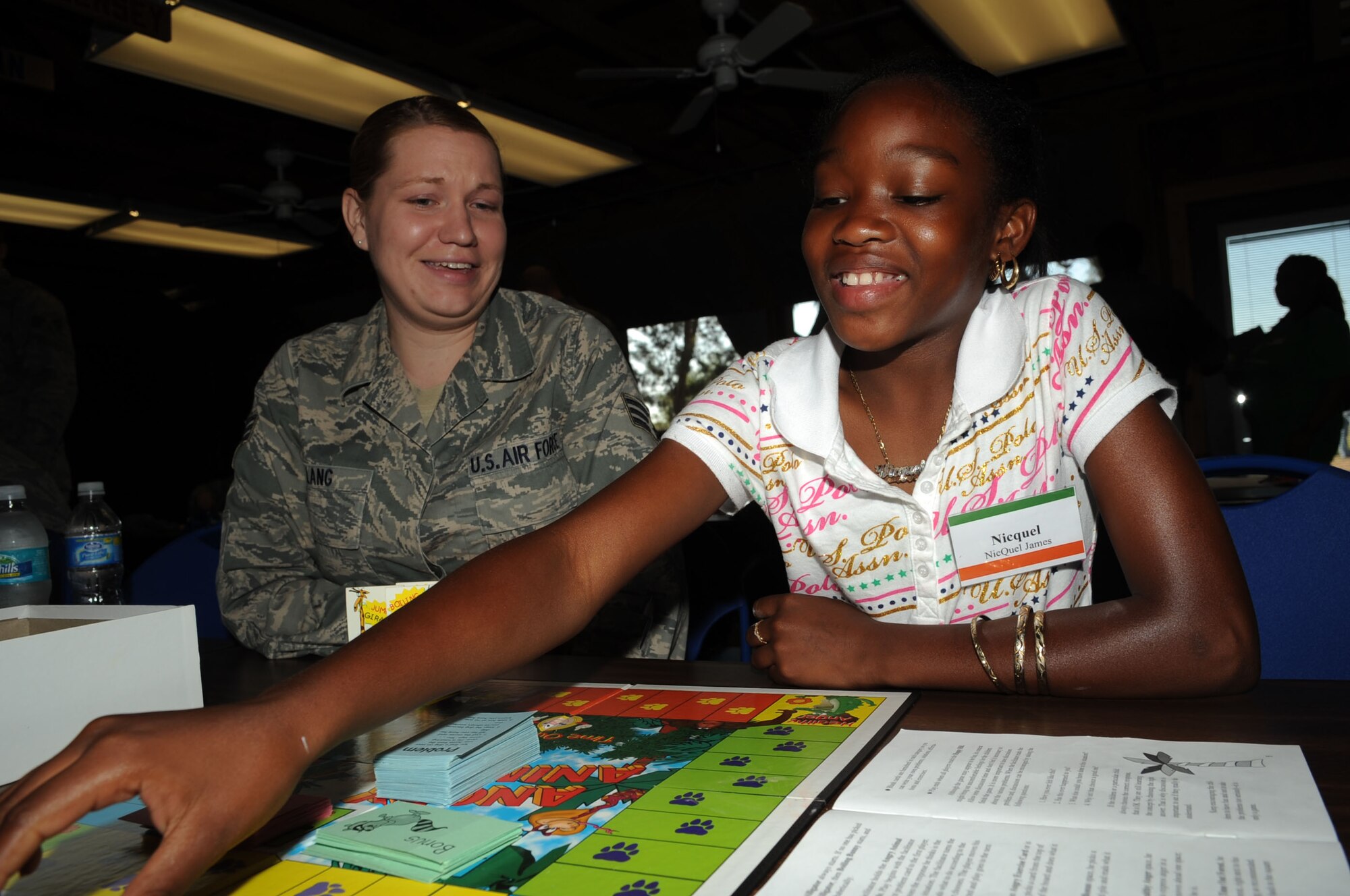 Senior Airman Shawna Lang, 6th Medical Operations Squadron, plays a board game with her little, Niquel James, during the Big for a Day Celebration May 1.  The Big Brothers/Sisters program visits Macdill AFB annually to foster mentorship between local children and base populace, while becoming familiar with 6th Air Mobility Wing mission. 