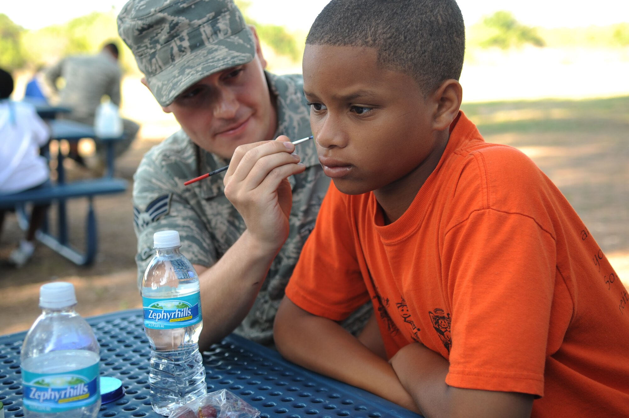 Senior Airman David Smelker, 6th Aircraft Maintenance Squadron, paints a spider on Devon Nance?s face during the ?Big for a Day? Celebration May 1, 2009.  The Big Brothers/Sisters program visits Macdill AFB annually to foster mentorship between local children and base populace, while becoming familiar with 6th Air Mobility Wing mission.  (U.S. Air Force photographer Senior Airman Nancy Hooks)