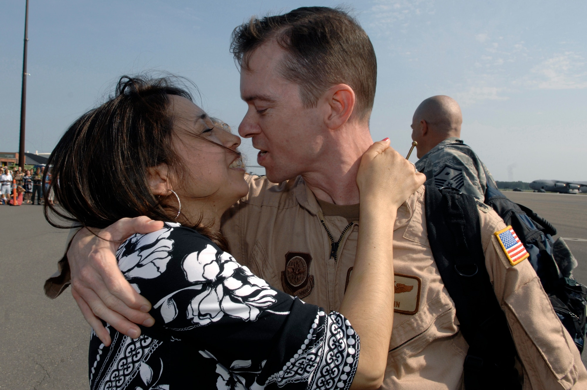 Lt. Col. Christopher Mann reunites with wife, Isabel, May 3 at Charleston Air Force Base, S.C., More than 140 Airmen from the 16th Airlift Squadron returned from their 120-day deployment to the Middle East in support of operations Enduring Freedom and Iraqi Freedom and operations in the Horn of Africa. During the deployment, 16th AS Airmen flew the C-17 Globemaster III with more than 3,000 sorties and 6,900 combat flying hours logged. Colonel Mann is the 16th AS commander. (U.S. Air Force photo/James M. Bowman) 