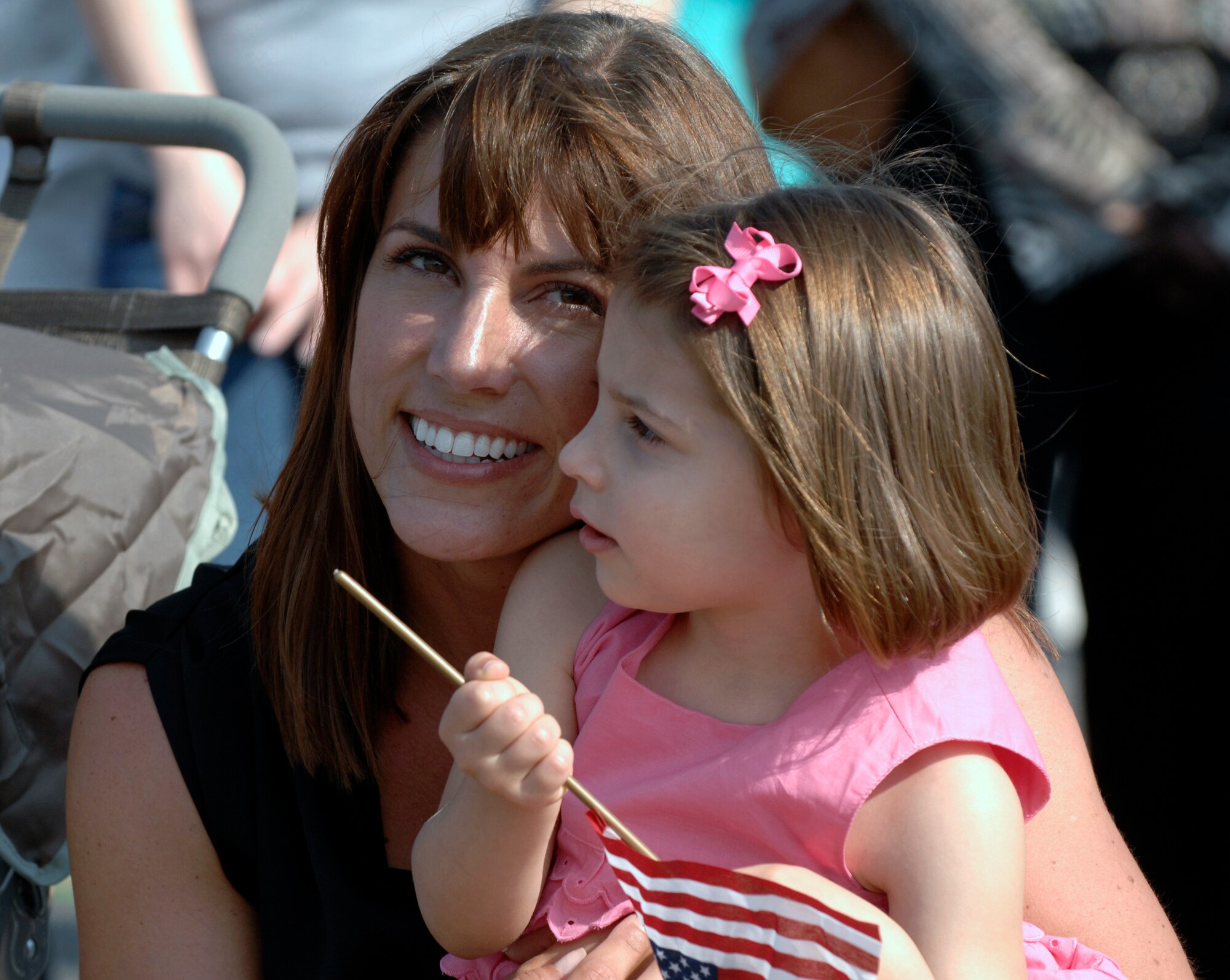 Katie Hall and daughter, Sophia, wait to reunite with Capt. Zachary Hall May 3 at Charleston Air Force Base, S.C. Captain Hall and more than 140 Airmen from the 16th Airlift Squadron returned from their 120-day deployment to the Middle East in support of operations Enduring Freedom and Iraqi Freedom and operations in the Horn of Africa. (U.S. Air Force photo/James M. Bowman) 
