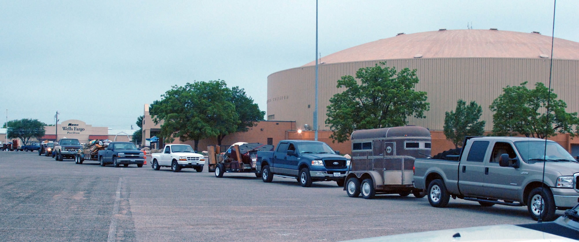 Vehicles begin to filter in for the large trash drop and recycling event held at the San Angelo Coliseum, Texas.  Almost 100 Airmen and Marines from Goodfellow Air Force Base lent a hand for a portion of the annual month-long Great American Cleanup, the nation's largest community improvement program, May 2.   As part of the Keep San Angelo Beautiful program, Team Goodfellow members took part in the day long event.  (U.S. Air Force photo by Senior Master Sgt. Robert Martinez)