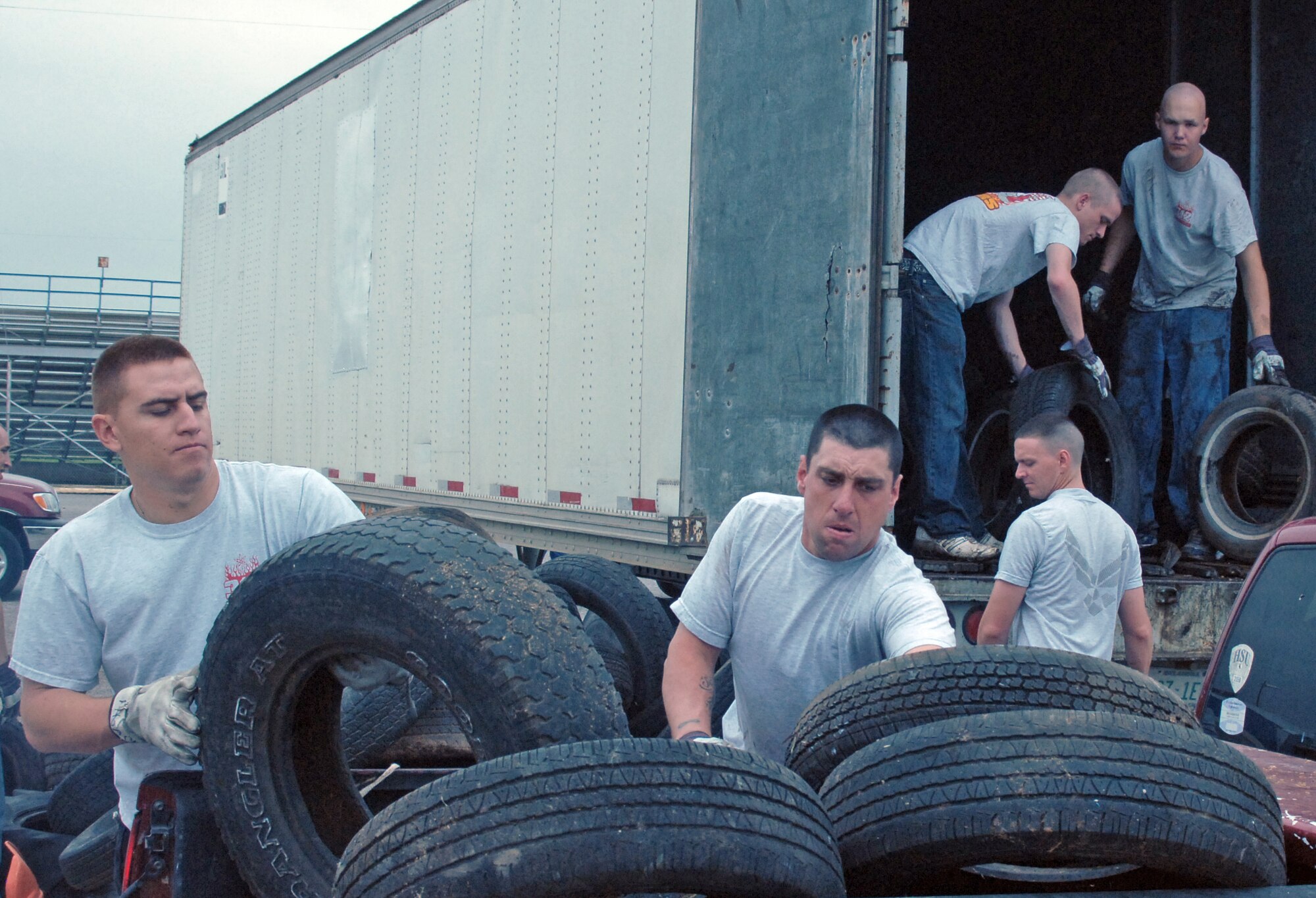 Airman John McCurley, native of Peoria, Ariz., and Airman Jackson Bailey, native of Lopez, Wash., both students from the 312th Training Squadron, Goodfellow Air Force Base, Texas, help with the tire recycling station.  Almost 100 Airmen and Marines from Goodfellow lent a hand for a portion of the annual month-long Great American Cleanup, the nation's largest community improvement program, May 2.   As part of the Keep San Angelo Beautiful program, Team Goodfellow members took part in the large trash drop and recycling event held at the San Angelo Coliseum, Texas.
(U.S. Air Force photo by Senior Master Sgt. Robert Martinez)