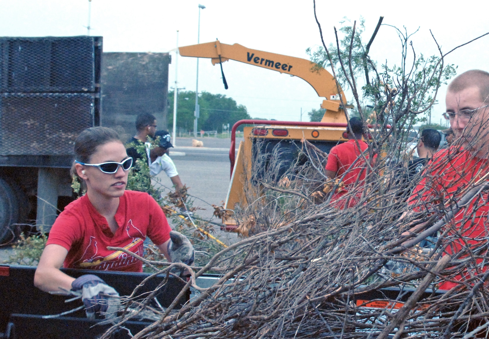 U.S. Air Force Airman 1st Class Surcheck, native of Indianapolis, Ind. a student of the 316th Training Squadron, Goodfellow Air Force Base, Texas, gathers branches to feed into a wood chipper.  Almost 100 Airmen and Marines from Goodfellow lent a hand for a portion of the annual month-long Great American Cleanup, the nation's largest community improvement program May 2.   As part of the Keep San Angelo Beautiful program, Team Goodfellow members took part in the large trash drop and recycling event held at the San Angelo Coliseum, Texas.
(U.S. Air Force photo by Senior Master Sgt. Robert Martinez)