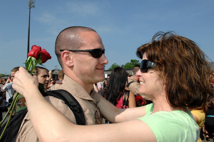 U.S. Air Force Master Sgt.  Kevin Kloeppel reunites with wife, Alison, at Charleston Air Force Base, S.C., May 3, 2009. More than 140 Airmen from the 16th Airlift Squadron returned from their 120-day deployment to the Middle East supporting Operations Enduring and Iraqi freedom and operations in the Horn of Africa. While deployed, the 16 AS executed 142 airdrops, more than any of its predecessors, which resupplied service members serving in the regions with 3.7 million pounds of supplies. Sergeant Kloeppel is a loadmaster for the 16 AS. (U.S. Air Force photo by James M. Bowman)(Released)
