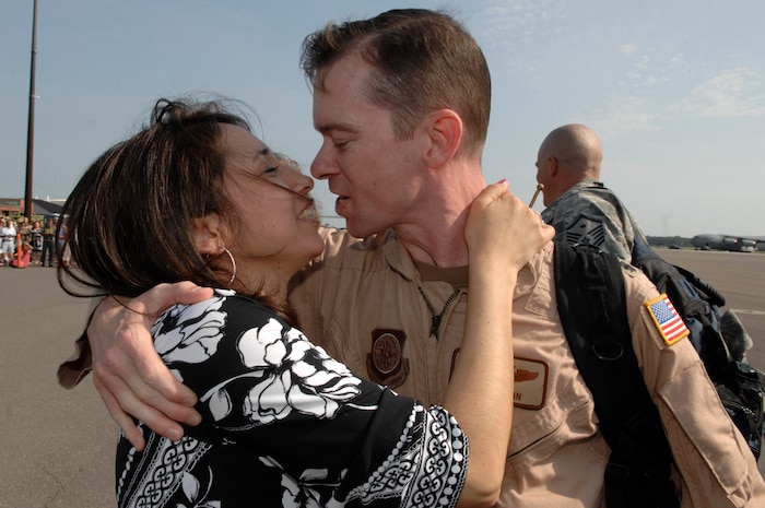 U.S. Air Force Lt. Col. Christopher Mann reunites with wife, Isabel, at Charleston Air Force Base, S.C., May 3, 2009. More than 140 Airmen from the 16th Airlift Squadron returned from their 120-day deployment to the Middle East in support of Operations Enduring and Iraqi Freedom and operations in the Horn of Africa. During the deployment, 16 AS Airmen flew the C-17 Globemaster III with more than 3,000 sorties and 6,900 combat flying hours logged. Lt. Col. Mann is the 16 AS squadron commander. (U.S. Air Force photo by James M. Bowman)(Released)