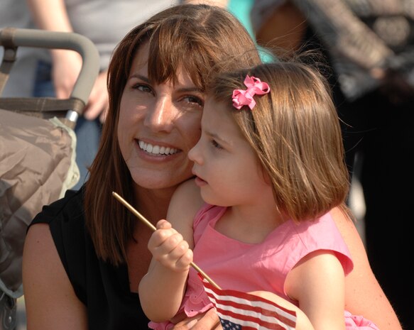 Katie Hall and daughter, Sophia, wait to reunite with U.S. Air Force Capt. Zachary Hall from the 16th Airlift Squadron at Charleston Air Force Base, S.C., May 3, 2009. More than 140 Airmen from the 16 AS from their 120-day deployment to the Middle East in support of Operations Enduring and Iraqi Freedom and operations in the Horn of Africa. (U.S. Air Force photo by James M. Bowman)(Released)