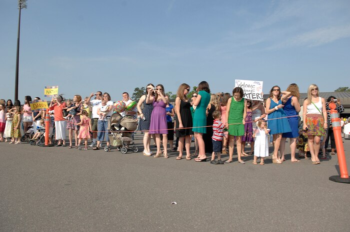 Family and friends wait to reunite with Airmen from the 16 Airlift Squadron at Charleston Air Force Base, S.C., May 3, 2009. More than 140 Airmen from the 16 AS returned from their 120-day deployment to the Middle East in support of Operations Enduring and Iraqi Freedom and operations in the Horn of Africa. (U.S. Air Force photo by James M. Bowman)(Released)