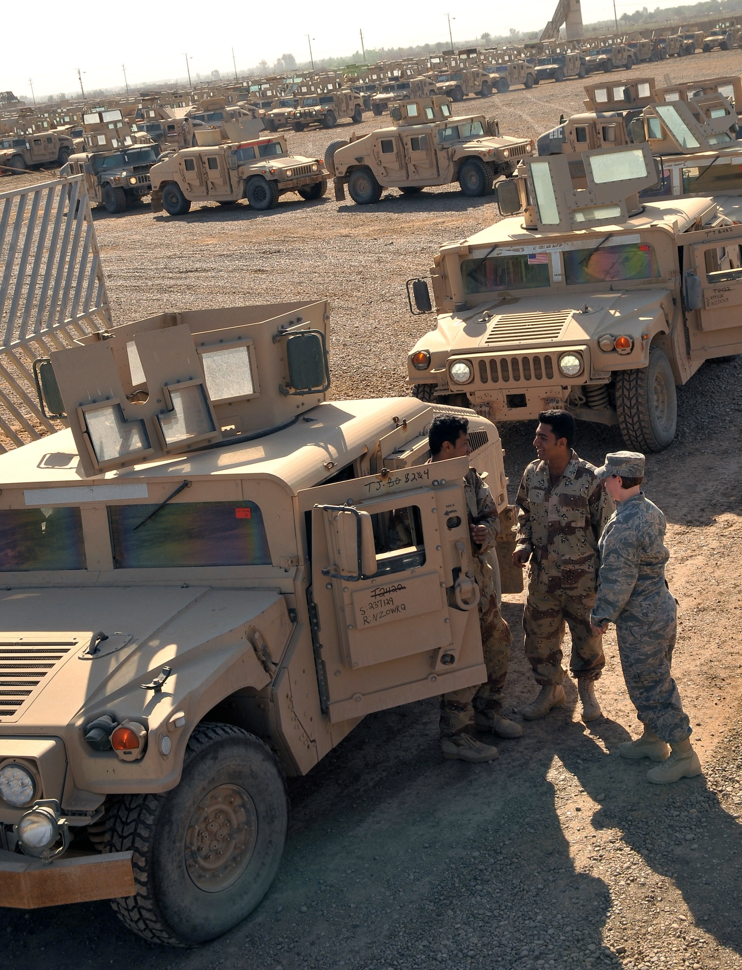 1st Lt. Victoria Smith speaks with Iraqi army soldiers prior to them driving M1114 Humvees to the Iraqi-run section in March at Camp Taji, Iraq. Lieutenant Smith is assigned to the 732nd Air Expeditionary Group and is the Taji Redistribution Property Assistance Team officer in charge. She is deployed from Holloman Air Force Base, N.M., and is a Colorado Springs, Colo., native. (U.S. Air Force photo/Staff Sgt. Dilia Ayala) 
