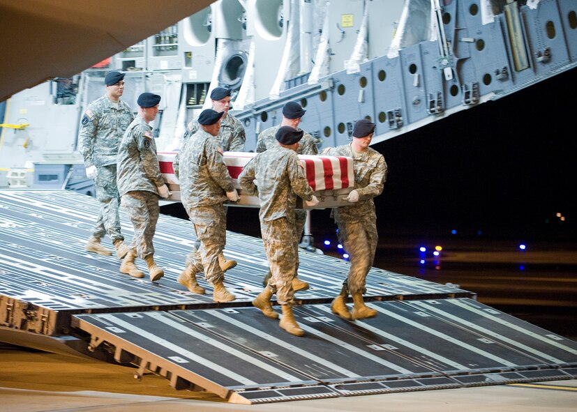 An Army carry team transfers the remains of Sgt. James D. Pirtle, 21, of Colorado Springs, Colo. He was assigned to the Special Troops Battalion, 3rd Brigade Combat Team, 1st Infantry Division, Fort Hood, Texas.  (U.S. Air Force photo/Tom Randle) 