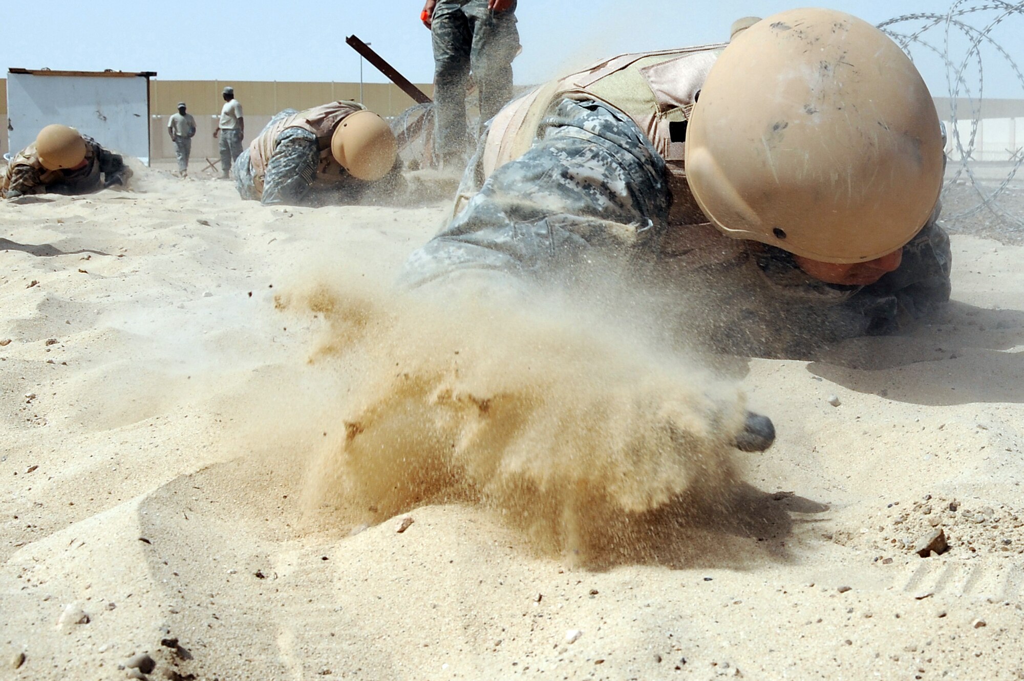 Army Sgt. Vincent McGoldrick pulls himself through a 25 foot sandpit on a Defender Challenge course April 25 at an air base in Southwest Asia. Teams from different units ran the course, testing stamina, strength and brain power. Sergeant McGoldrick is assigned to the 5-52 Air Defense Artillery Battalion deployed out of Fort Bliss, Texas. (U.S. Air Force photo/Senior Airman Brian J. Ellis) 