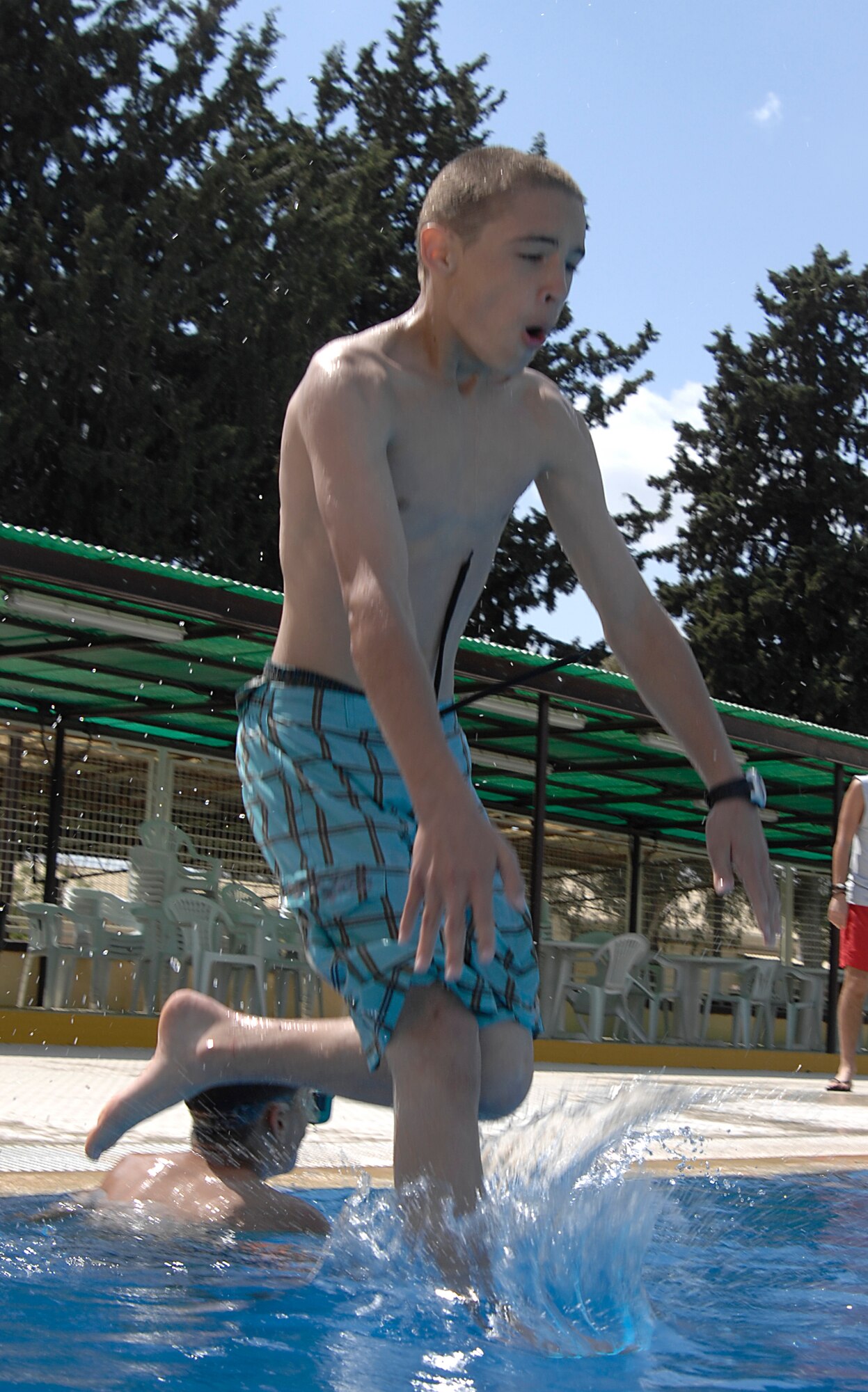 Michael Seward jumps into the deep end of the Incirlik pool during its opening day, May 2, 2009. The pool is now open for open swim in the weekends and lap swim during the week at designated hours. The facilities at the pool include a water slide, diving board, children’s area and areas to sunbath and relax. (U.S. Air Force photo/Senior Airman Benjamin Wilson)