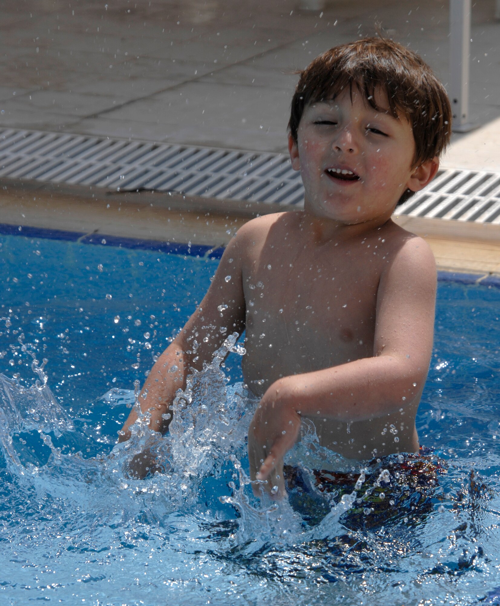 Brandon Trail plays in the water of the Incirlik pool during its opening day, May 2, 2009. The pool is now open for open swim in the weekends and lap swim during the week at designated hours. The facilities at the pool include a water slide, diving board, children’s area and areas to sunbath and relax. (U.S. Air Force photo/Senior Airman Benjamin Wilson)