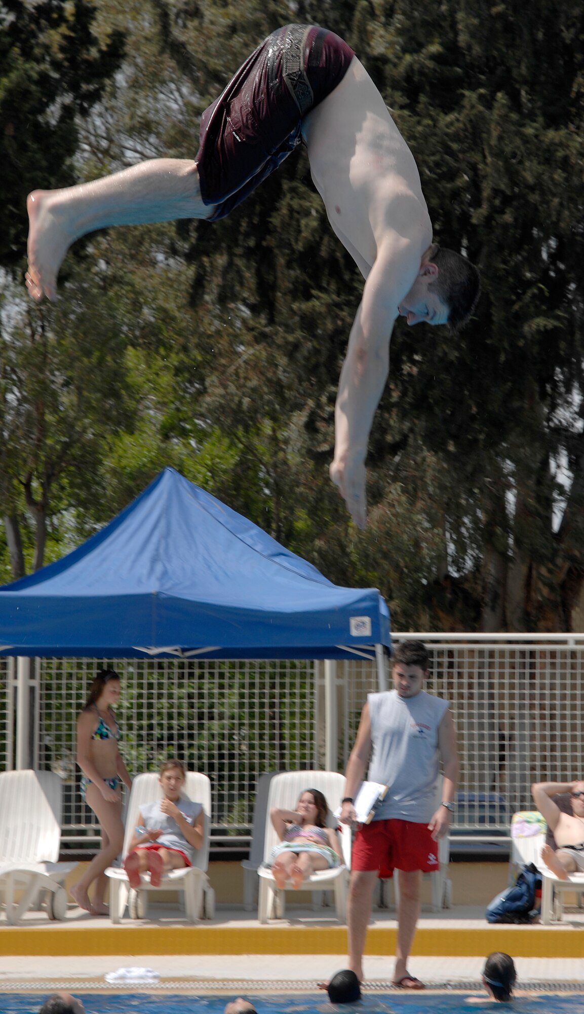 1st Lieutenant Alexander Hanna, 817 Expeditionary Airlift Squadron, dives into the Incirlik pool during its opening day, May 2, 2009. The pool is now open for open swim in the weekends and lap swim during the week at designated hours. The facilities at the pool include a water slide, diving board, children’s area and areas to sunbath and relax. (U.S. Air Force photo/Senior Airman Benjamin Wilson)