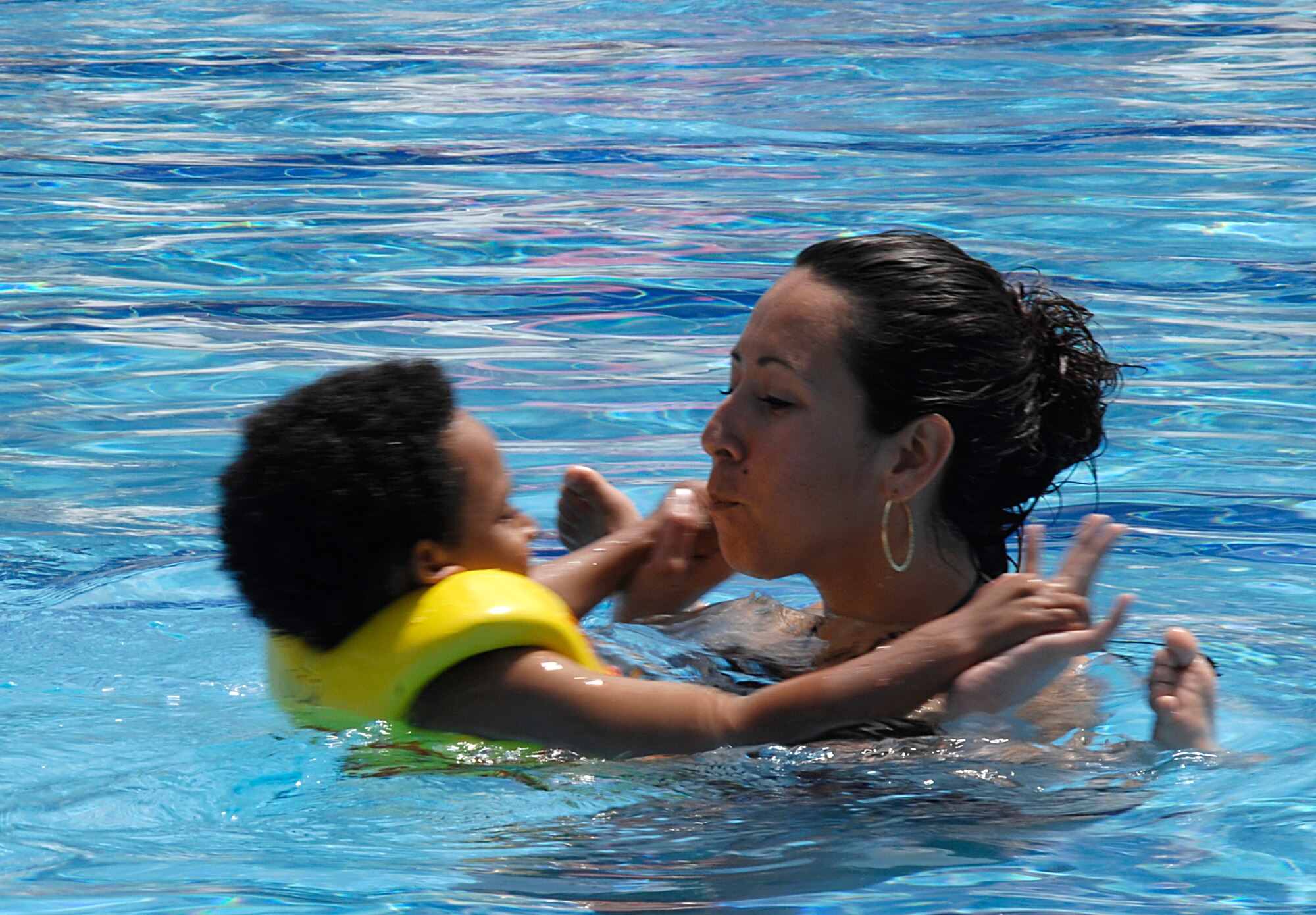 Senior Airman Michelle Jones, 39th Medical Operations Squadron, Swims with her son, Micah, in the Incirlik pool during its opening day, May 2, 2009. The pool is now open for open swim in the weekends and lap swim during the week at designated hours. The facilities at the pool include a water slide, diving board, children’s area and areas to sunbath and relax. (U.S. Air Force photo/Senior Airman Benjamin Wilson)