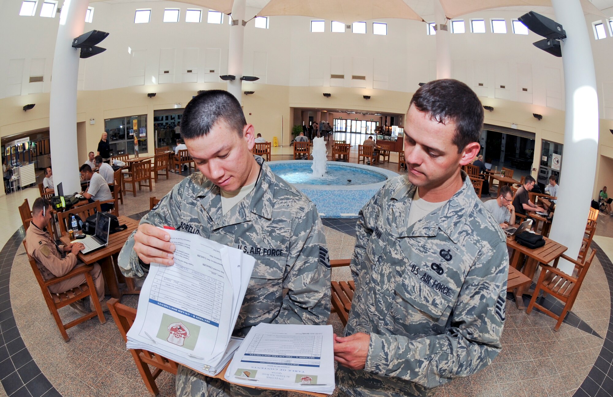 Staff Sgt. Joseph Borello, and Staff Sgt. John Grogan, both contracting officers with the 379th Expeditionary Contracting Squadron, review the wireless services contract for an upcoming bandwidth expansion planned for the base at one of the central wireless hubs here, May 3, 2009, in an undisclosed location in Southwest Asia.  Sergeant Borello is the person who has been working with the local internet service provider to ensure base personnel can obtain the best service possible.  Sergeant Borello is native to Niceville, Fla. and is deployed from MacDill Air Force Base, Fla. while Sergeant Grogan hails from Atwater, Calif. and is deployed from Shaw Air Force Base, S.C. both in support of Operations Iraqi and Enduring Freedom and Combined Joint Task Force - Horn of Africa.  (U.S. Air Force Photo by Staff Sgt. Joshua Garcia/released)