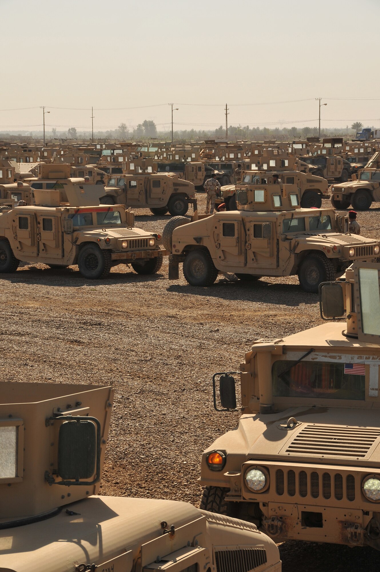 CAMP TAJI, Iraq - U.S. and Iraqi Army Soldiers drive M1114 HMMWVs to the Iraqi-run section of the camp here for processing. The Soldiers work with the Taji Redistribution Property Assistance Team to process M1114 up-armored HMMWVs that will be sold to the Iraqi government. The HMMWVs will later be distributed to Iraqi Army and Police for use during day-to-day operations. (U.S. Air Force photo/Staff Sgt. Dilia Ayala)
