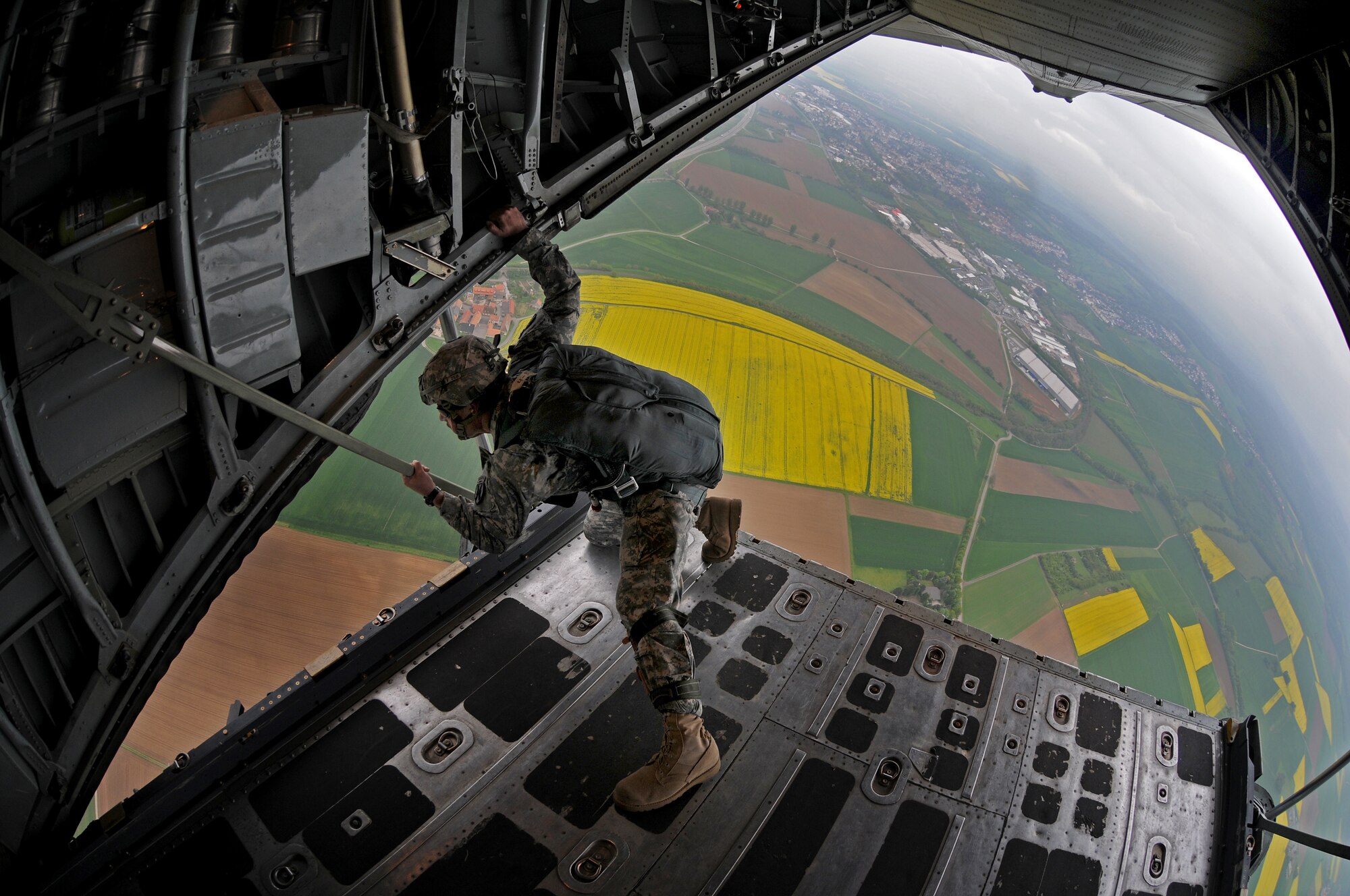 United States Army Sgt. Juan Felix, 5th Quartermaster Company safety officer, performs a pre-jump check prior to paratroopers jumping out a C-130E over southern Germany, April 30, 2009. The jump was conducted as part of the celebration for the Contingency Readiness Group's 10th anniversary.(U.S. Air Force photo by Airman 1st Class Grovert Fuentes-Contreras)