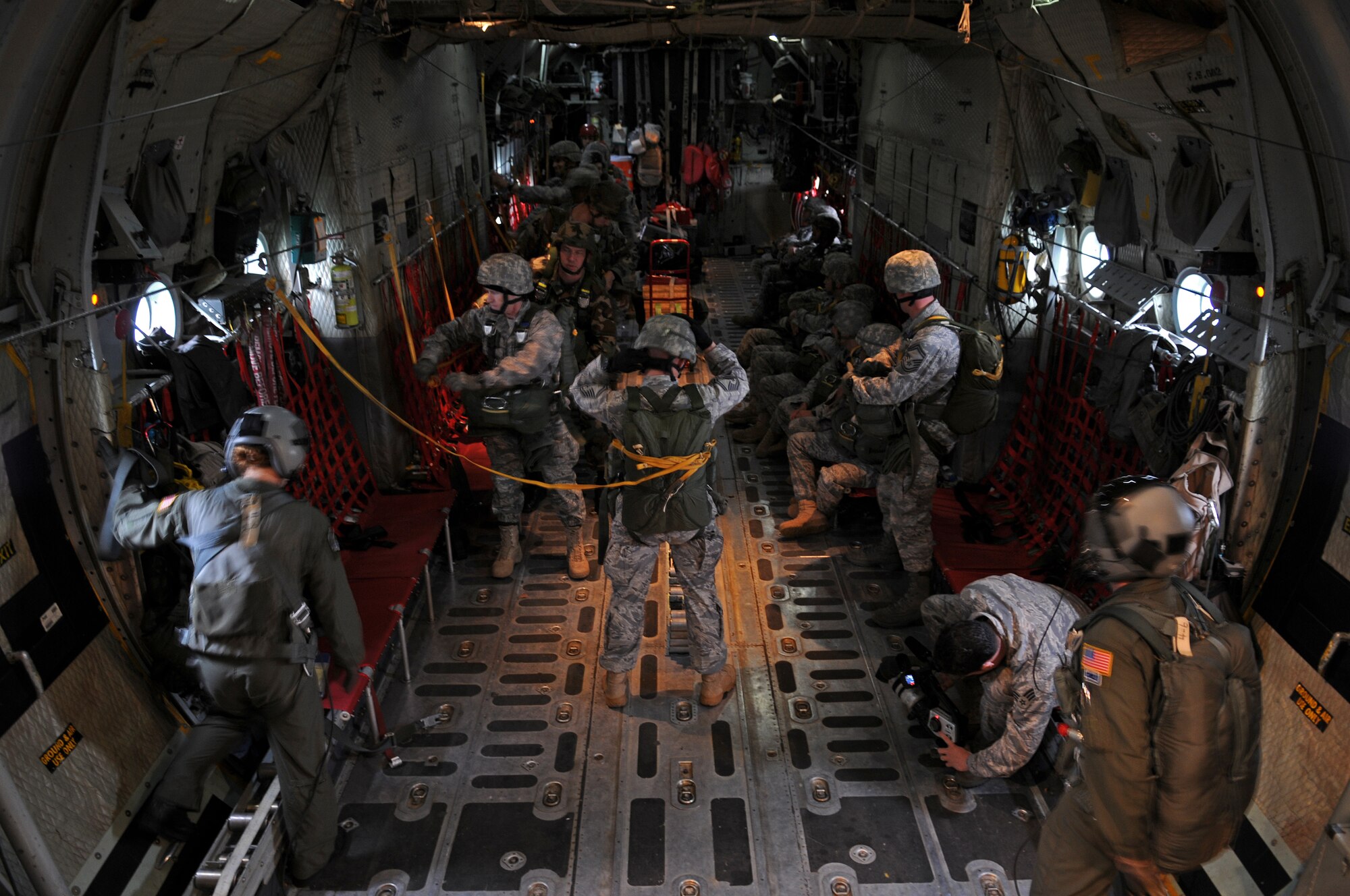 United States Air Force paratroopers prepare to execute a jump out the back of a C-130E Hercules over southern Germany, April 30, 2009. The jump was conducted as part of the celebration for the Contingency Readiness Group's 10th anniversary. (U.S. Air Force photo by Airman 1st Class Grovert Fuentes-Contreras)