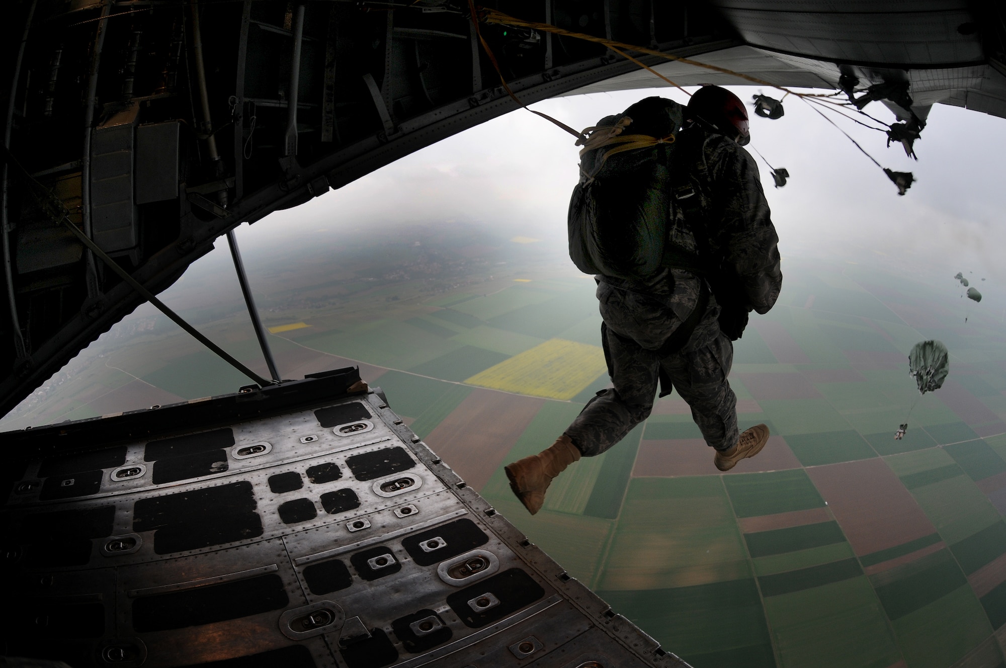 United States Air Force paratroopers execute a jump out the back of a C-130E Hercules over southern Germany, April 30, 2009. The jump was conducted as part of the celebration for the Contingency Readiness Group's 10th anniversary. (U.S. Air Force photo by Airman 1st Class Grovert Fuentes-Contreras)