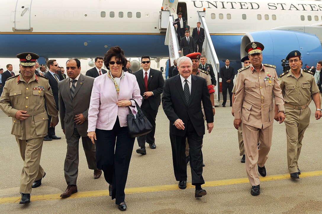 U.S. Defense Secretary Robert M. Gates, center, walks with U.S. Ambassador to Egypt Margaret Scobey and Egyptian officials during his arrival in Cairo, Egypt, May 4, 2009.