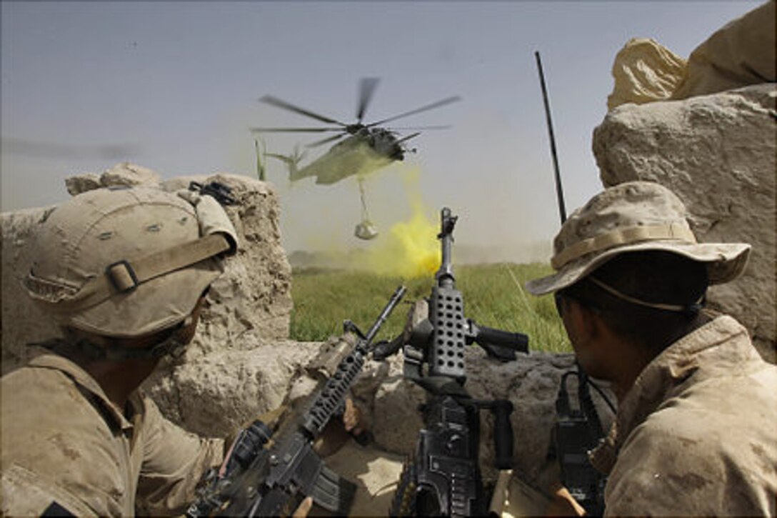 Infantry Marines in Hellmand Province Afghanistan receive much needed chow and water for the Hustlers of HMH-772.