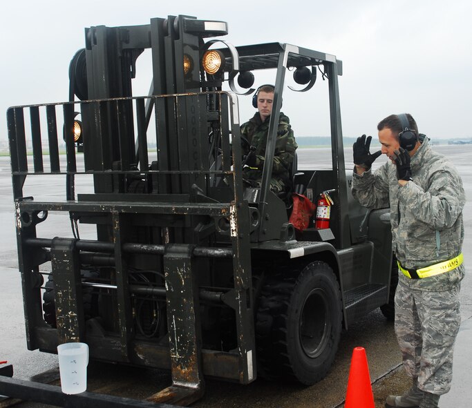 YOKOTA AIR BASE, Japan -- Airman 1st Class Colin Middleton (right) guides Airman 1st Class Benjamin Griggs as he drives a10K forklift May 6 through an obstacle course during the 730th Air Mobility Squadron's Transportation Round-Up. The Round-Up is designed to provide a healthy competition among squadron members and is focused on the core capabilities of air mobility Airmen.(U.S. Air Force photo/Airman Sean Martin)