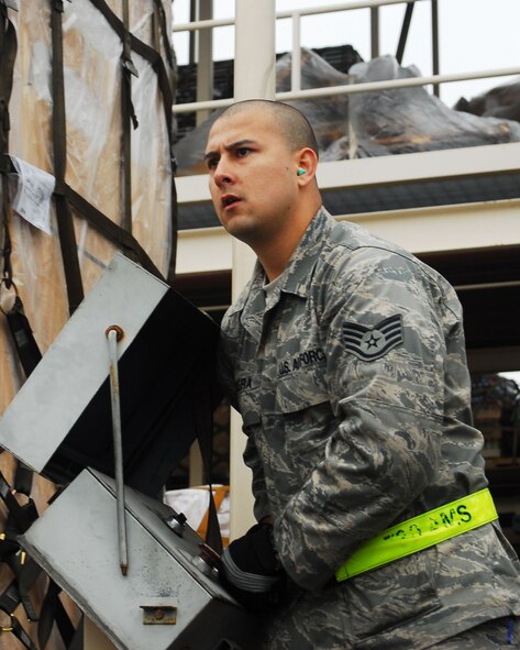 YOKOTA AIR BASE, Japan -- Staff Sgt. Jesus Rivera guides pallets off a 60K loader  May 6 during the 730th Air Mobility Squadron's Transportation Round-Up. The Round-Up is designed to provide a healthy competition among squadron members and is focused on the core capabilities of air mobility Airmen. (U.S. Air Force photo/Airman Sean Martin)